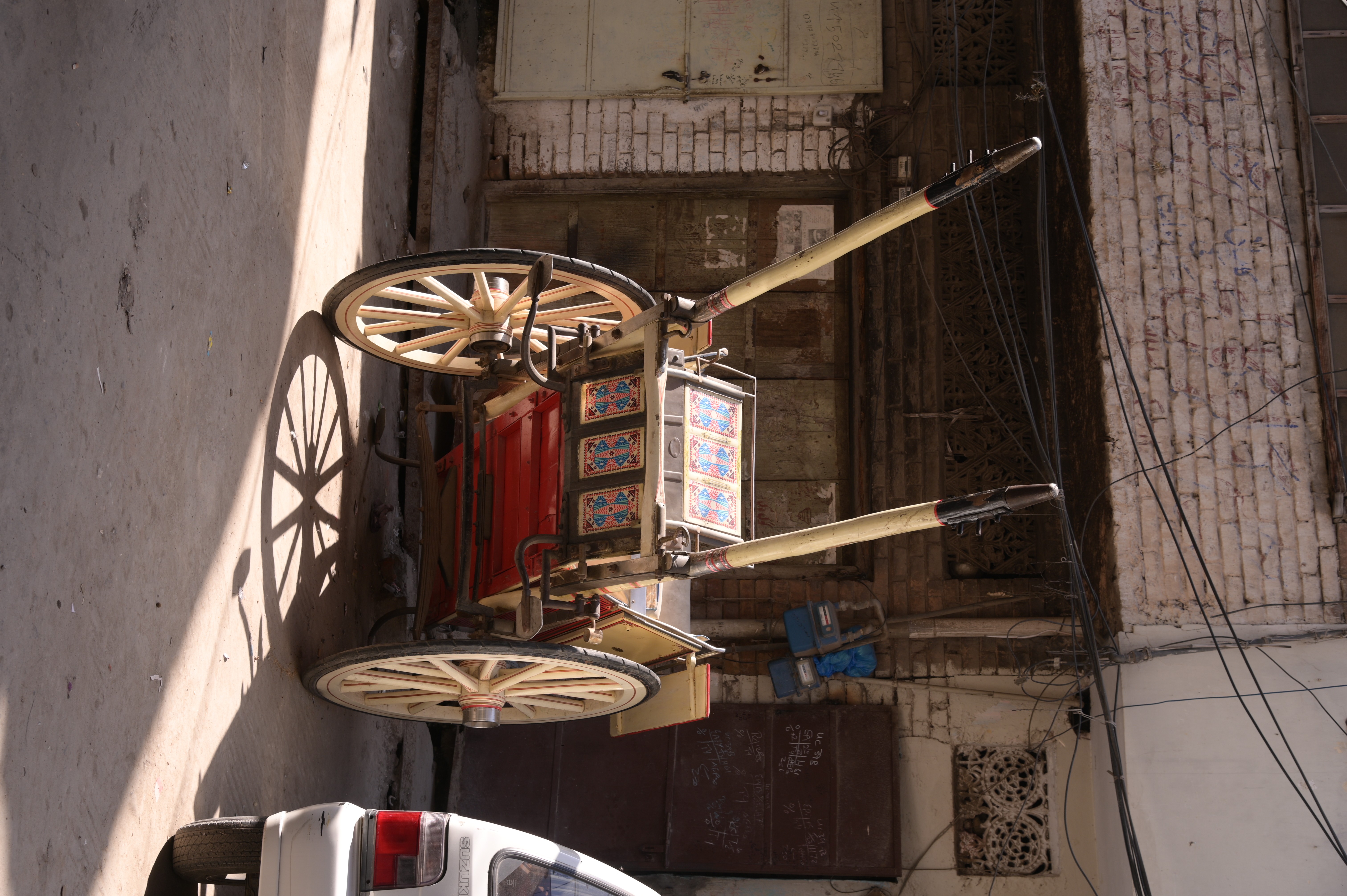 A man push cart on which people travel across the city