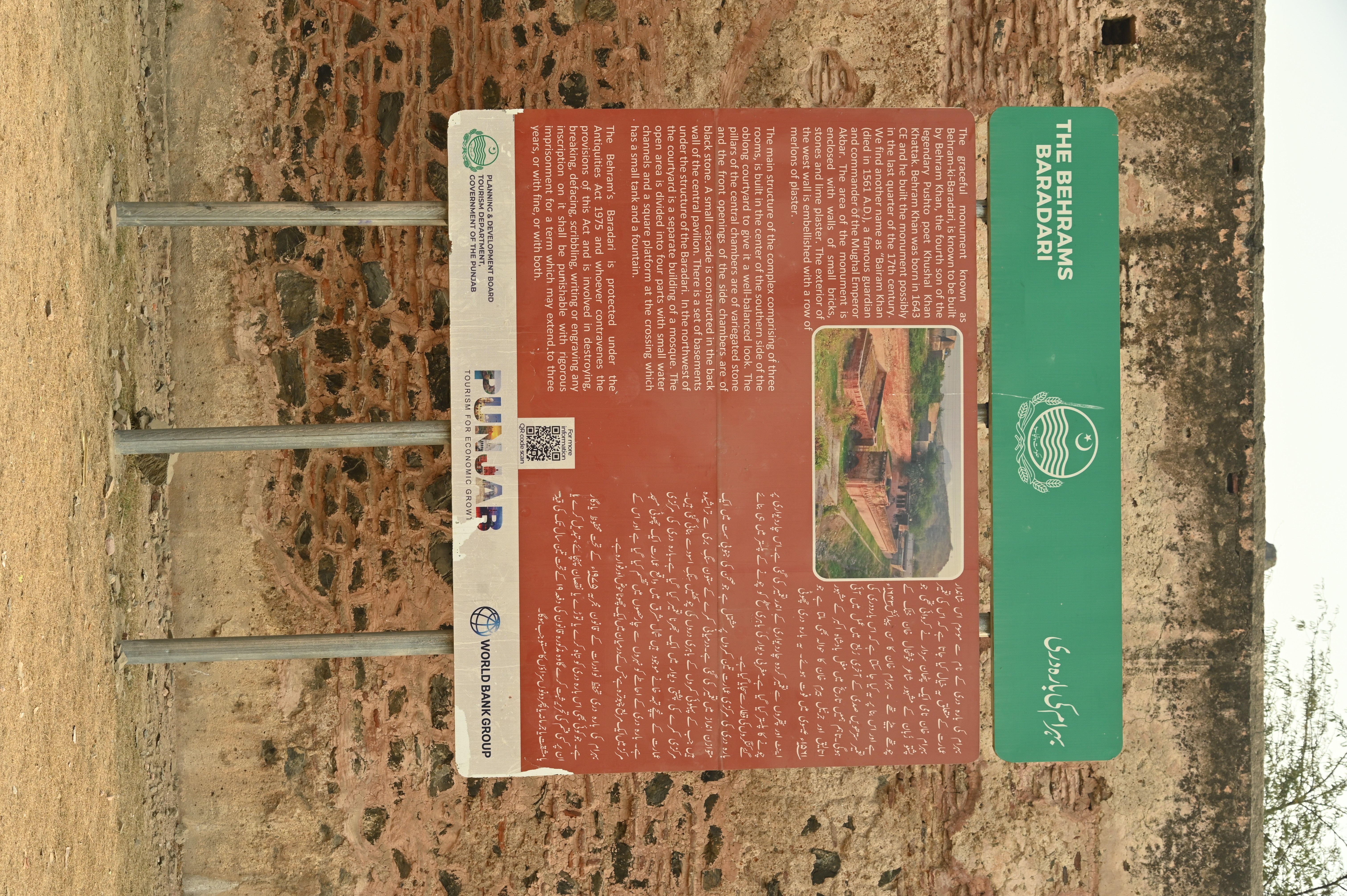 The information board explaining the historical structure and the constructional style of the archaeological site named "Behram ki Baradari"
