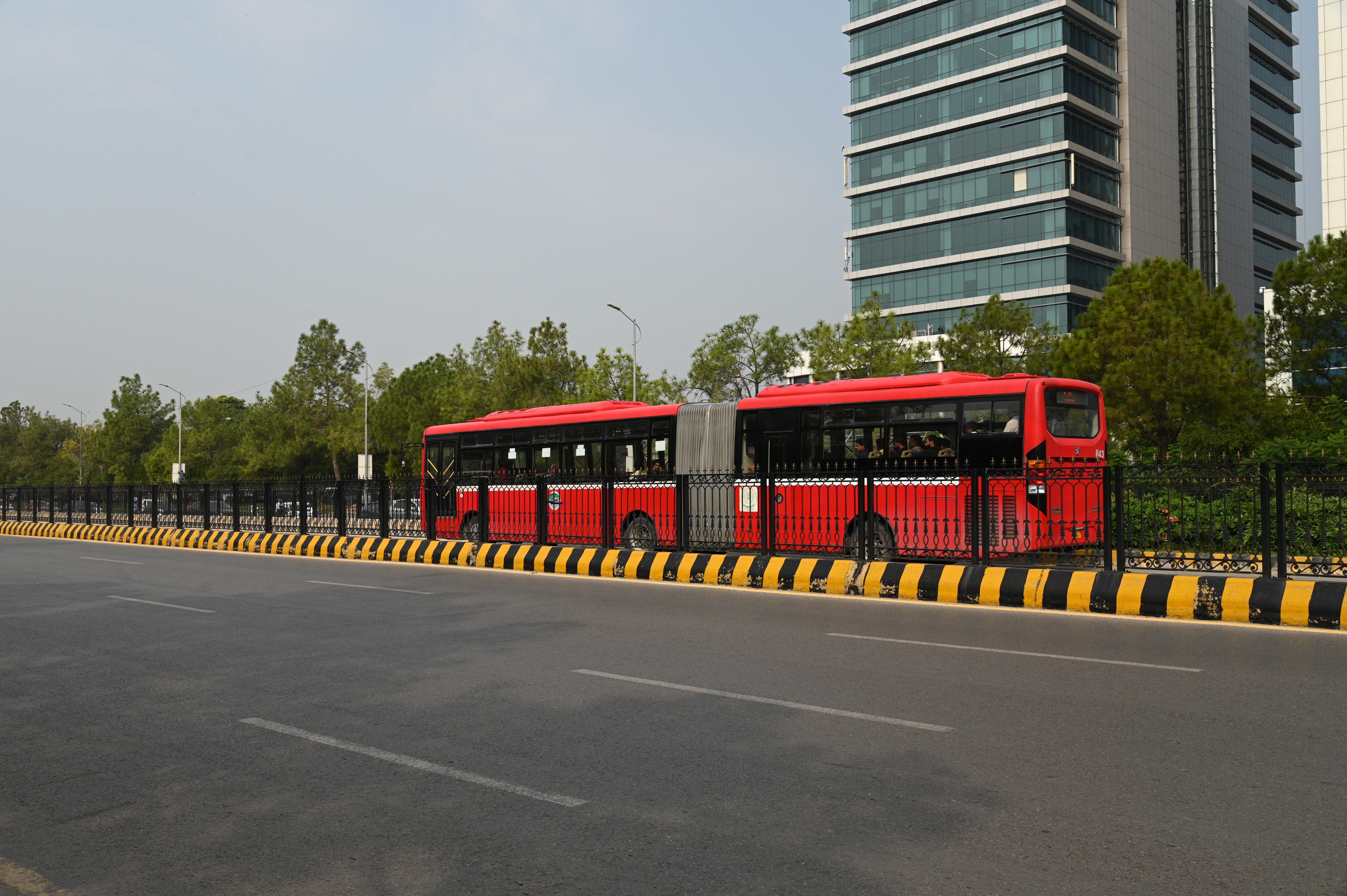A metro bus passing by the blue area metro bus track