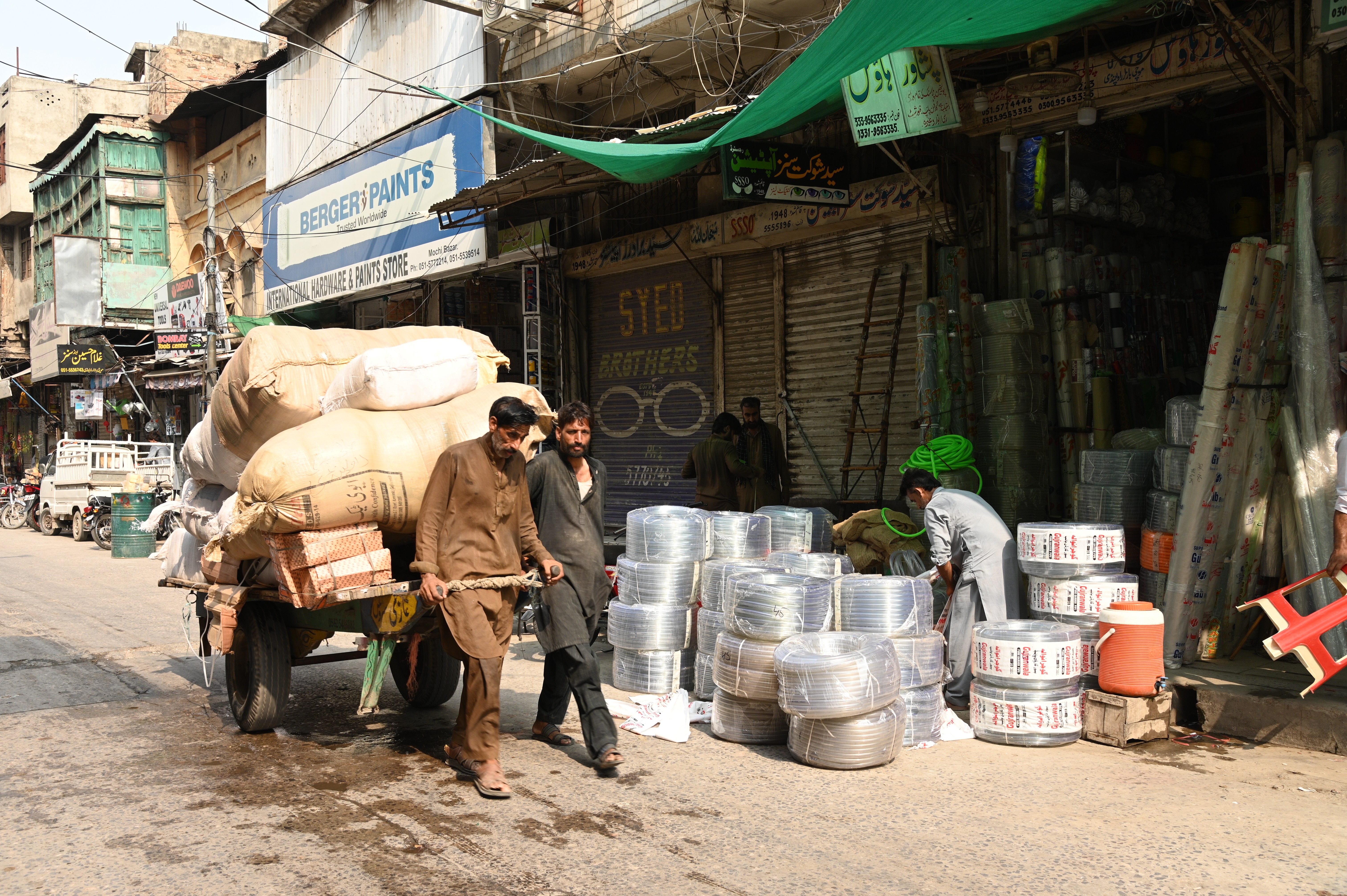 a man setting up his shop of polythene goods