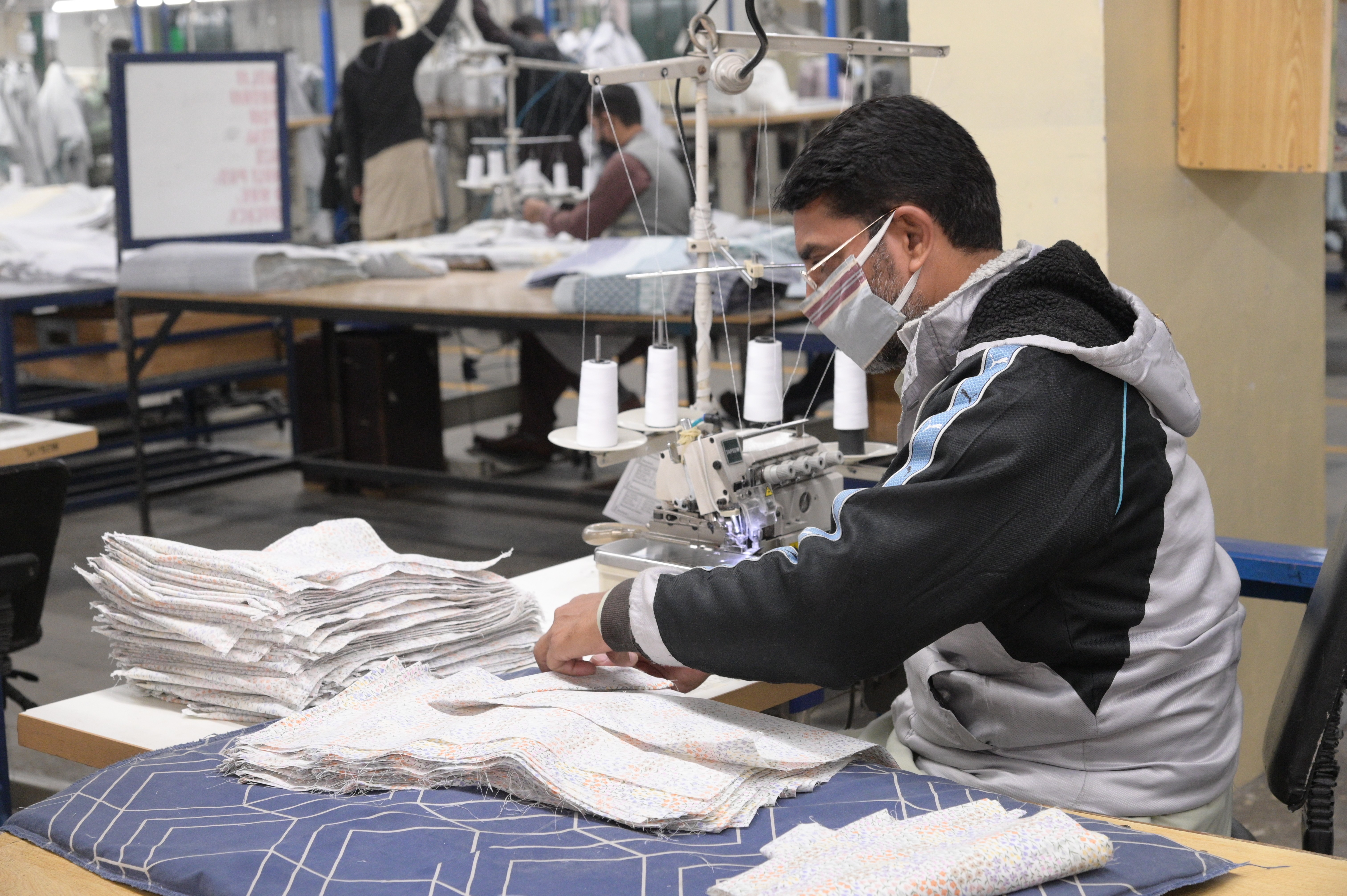 A man cutting cloth pieces in the textile industry