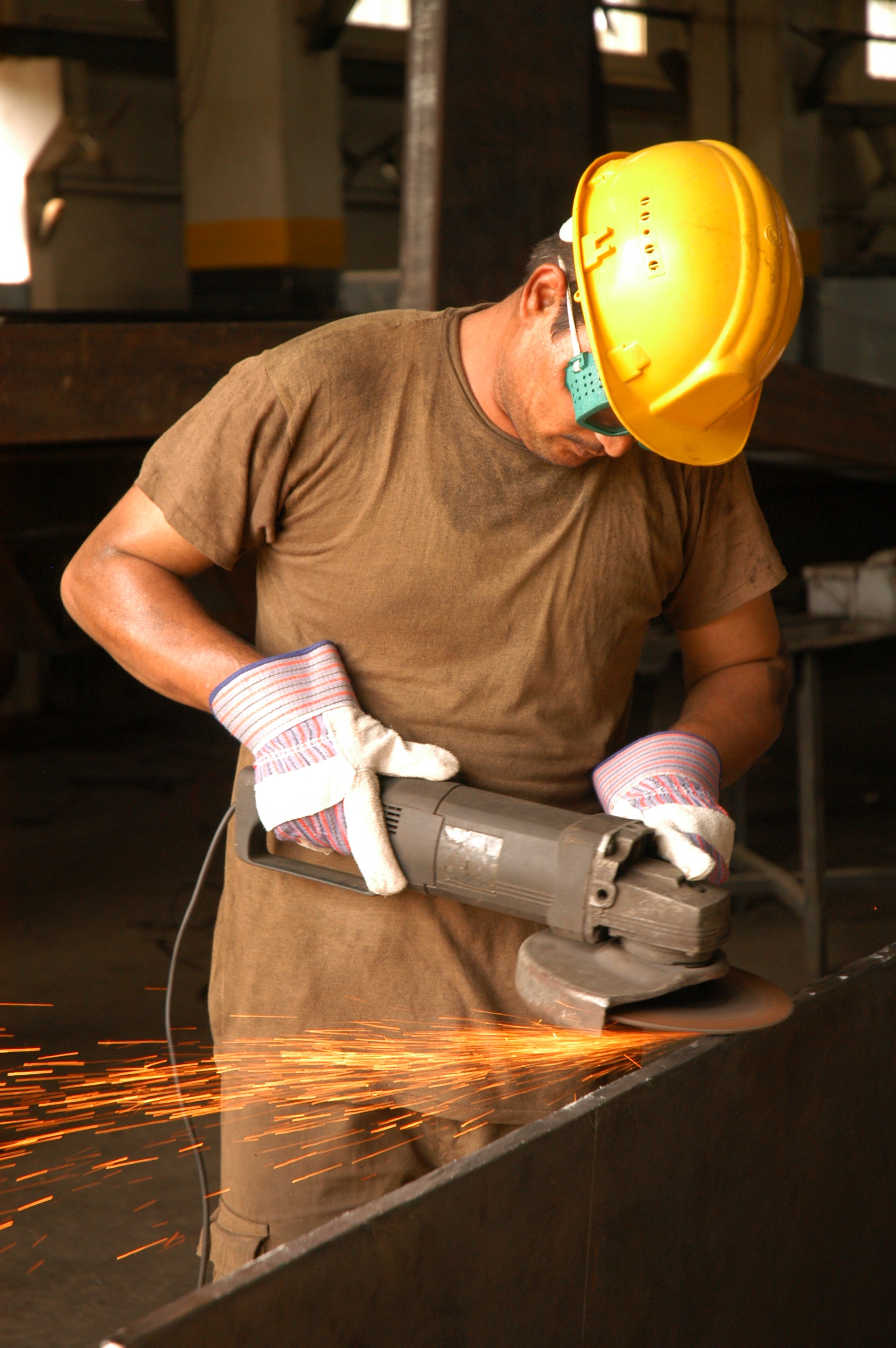 Worker using metal cutting circular saw blade in constuction site.