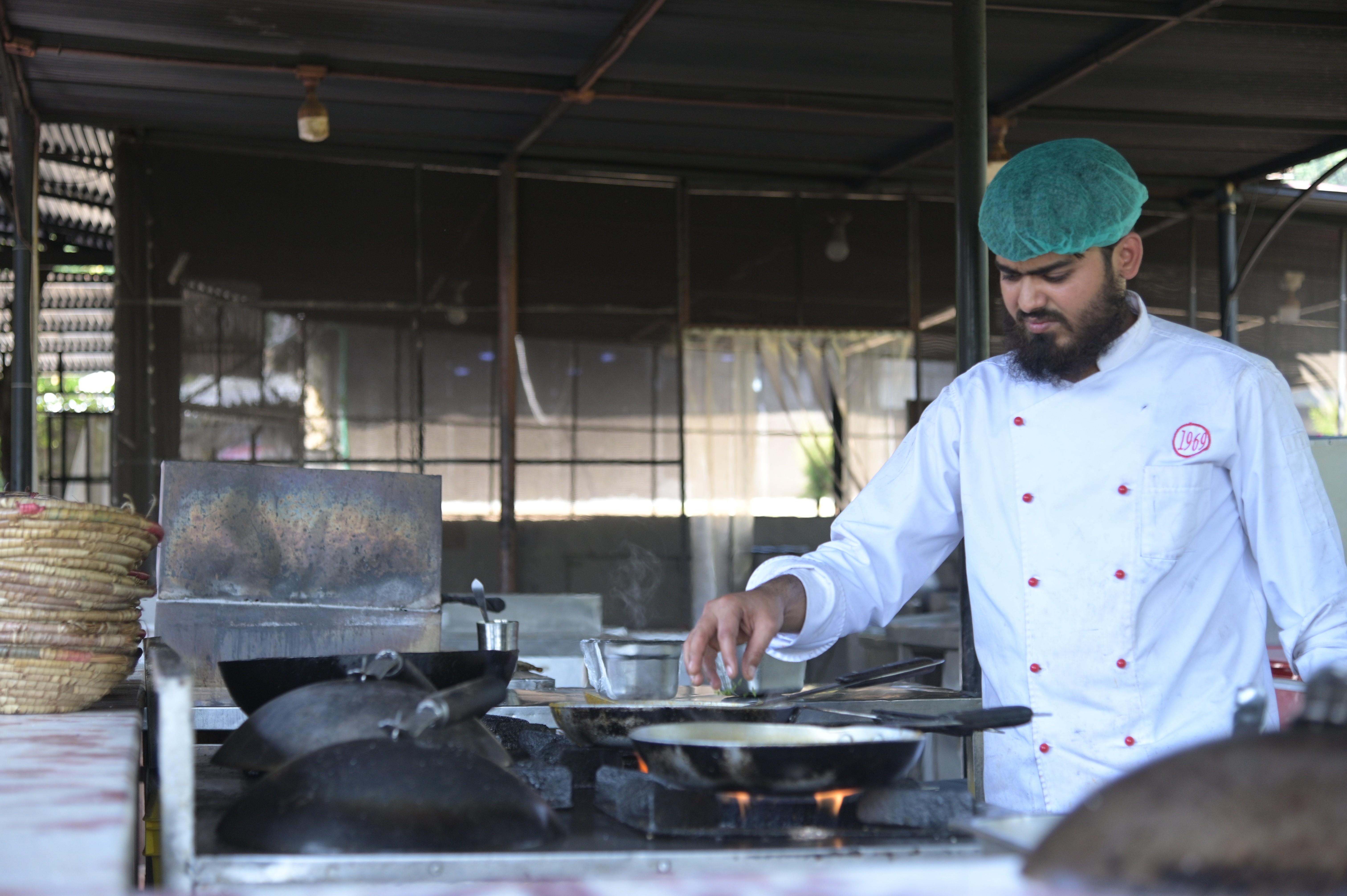 The chef busy in making food for the restaurant