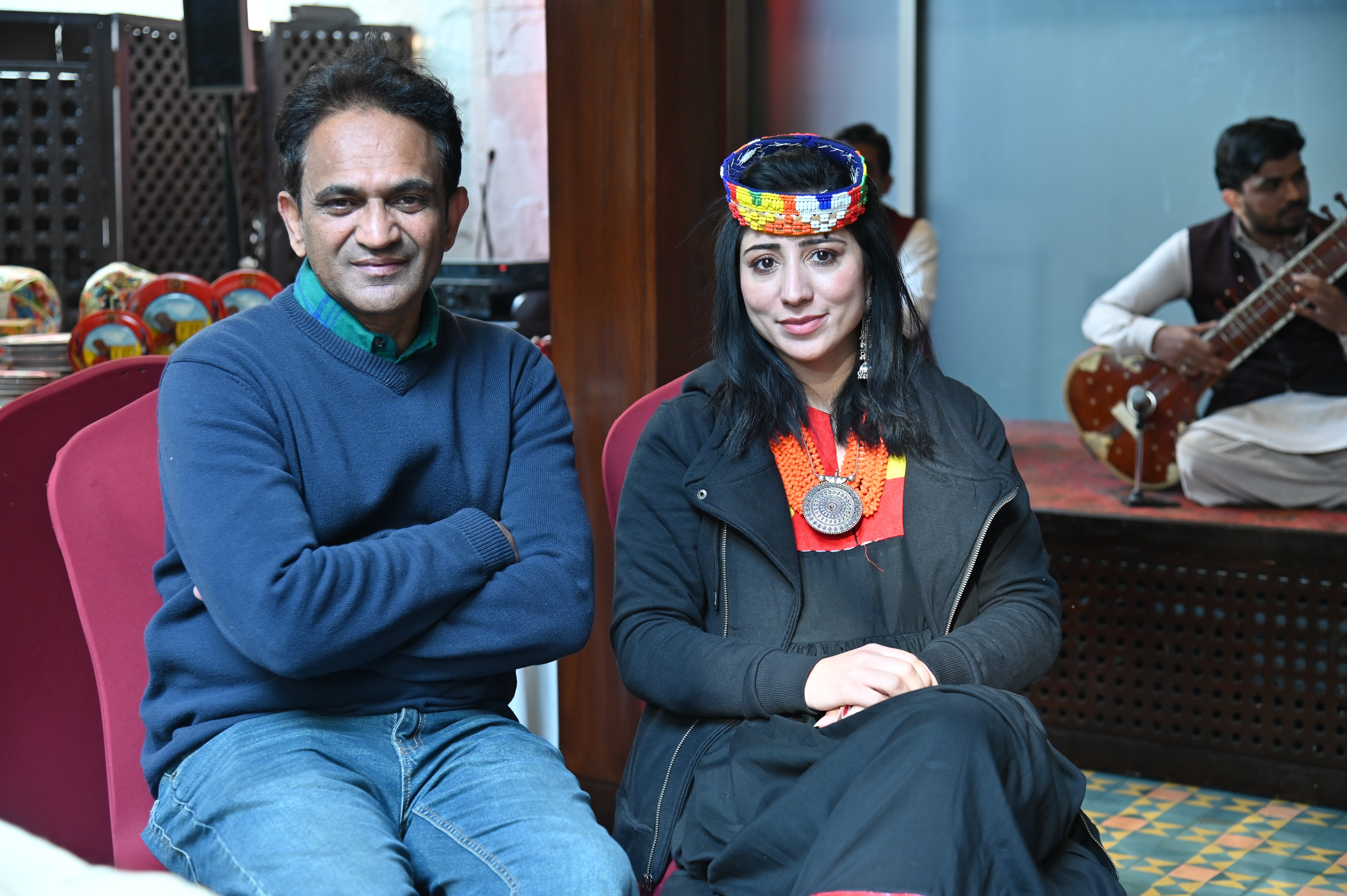 An organizer with women symbolizing the northern culture of Pakistan  by wearing an ethenic traditional cap made of colorful beads