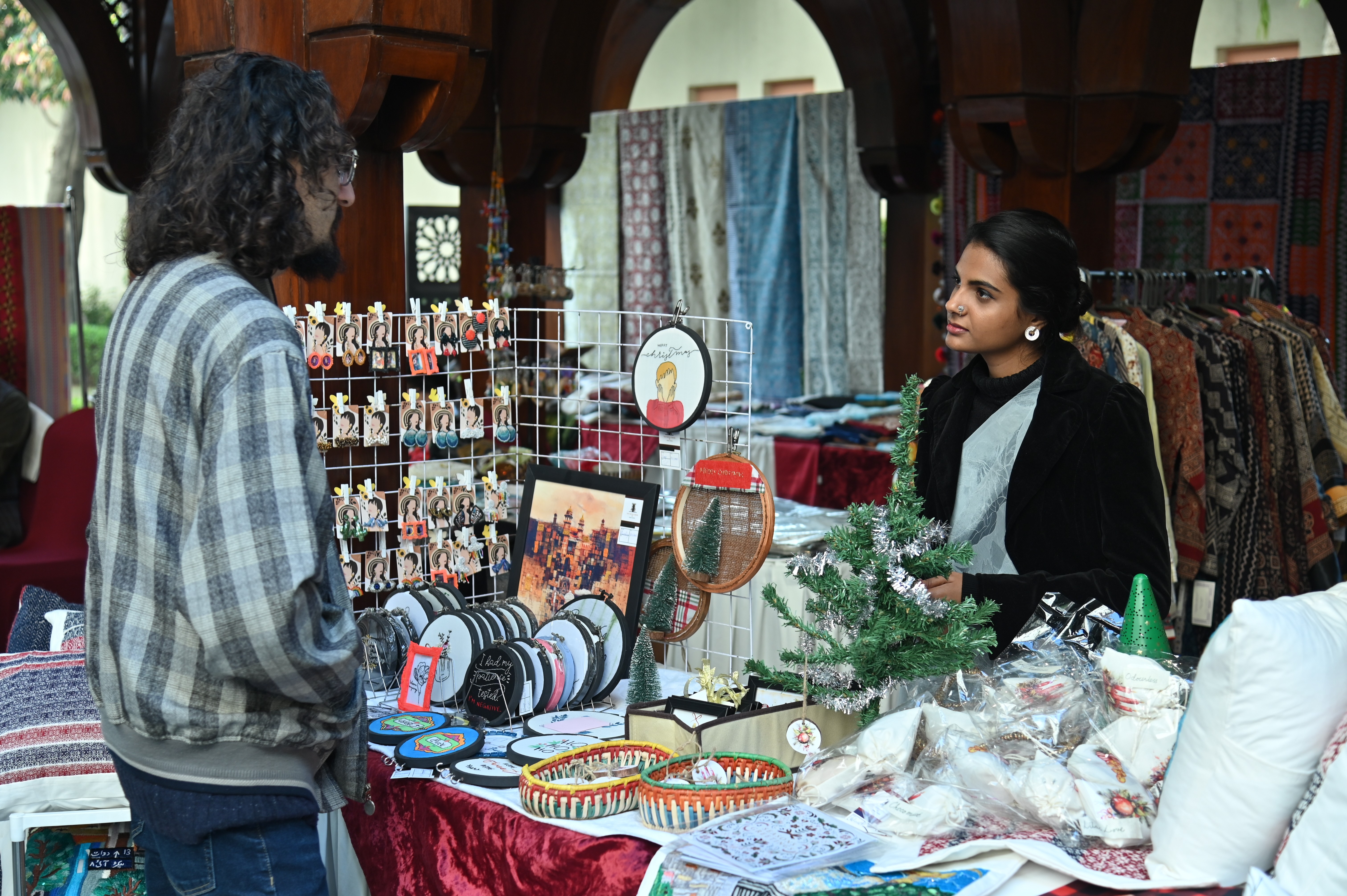 A man having a stall of hand-made colorful greeting cards