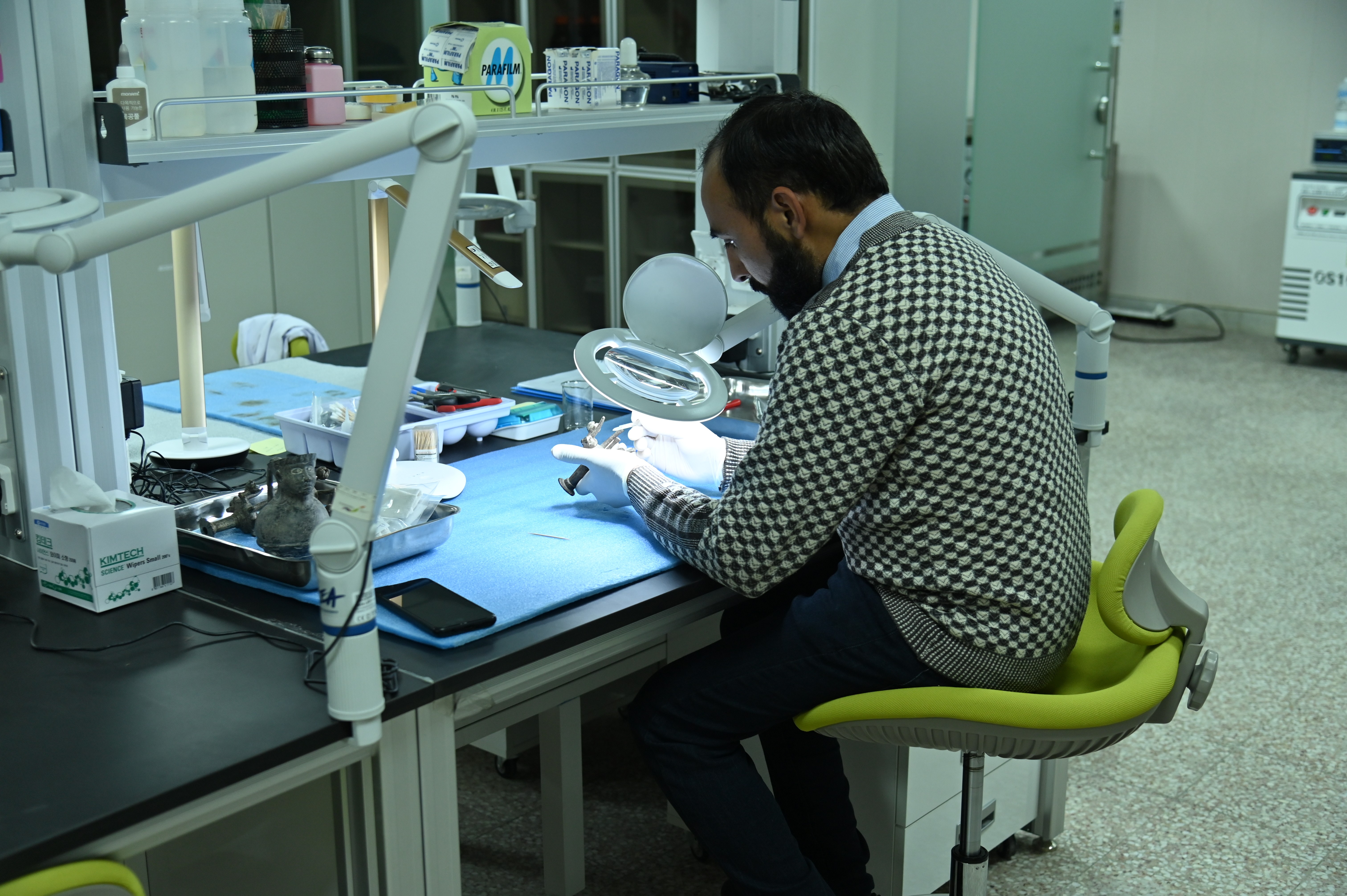 A researcher busy in conserving the artifact manuually at The Gandhara Cultural Heritage Research Center