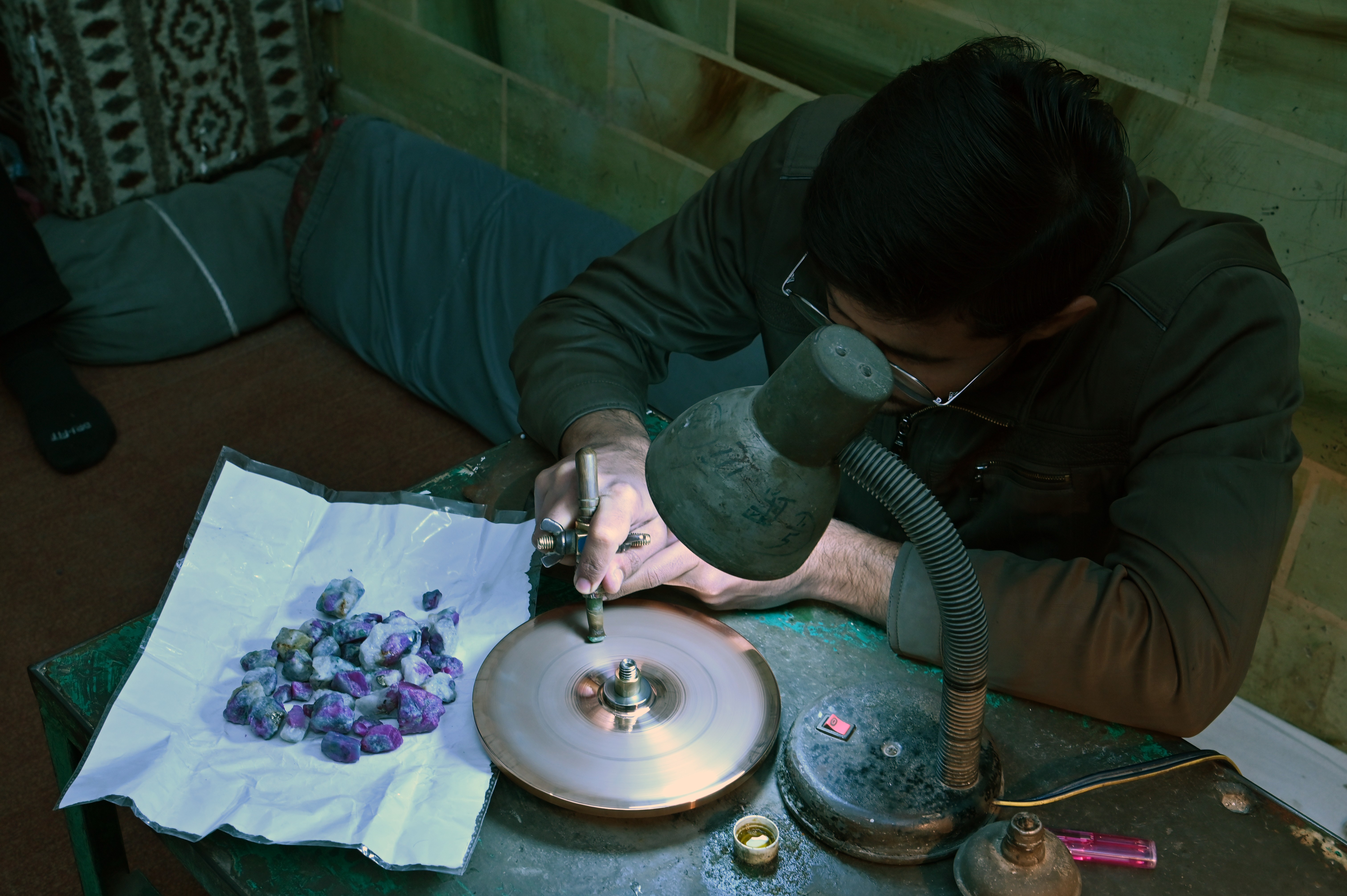 A man busy in refining the stones in the Gems and Crystals Market