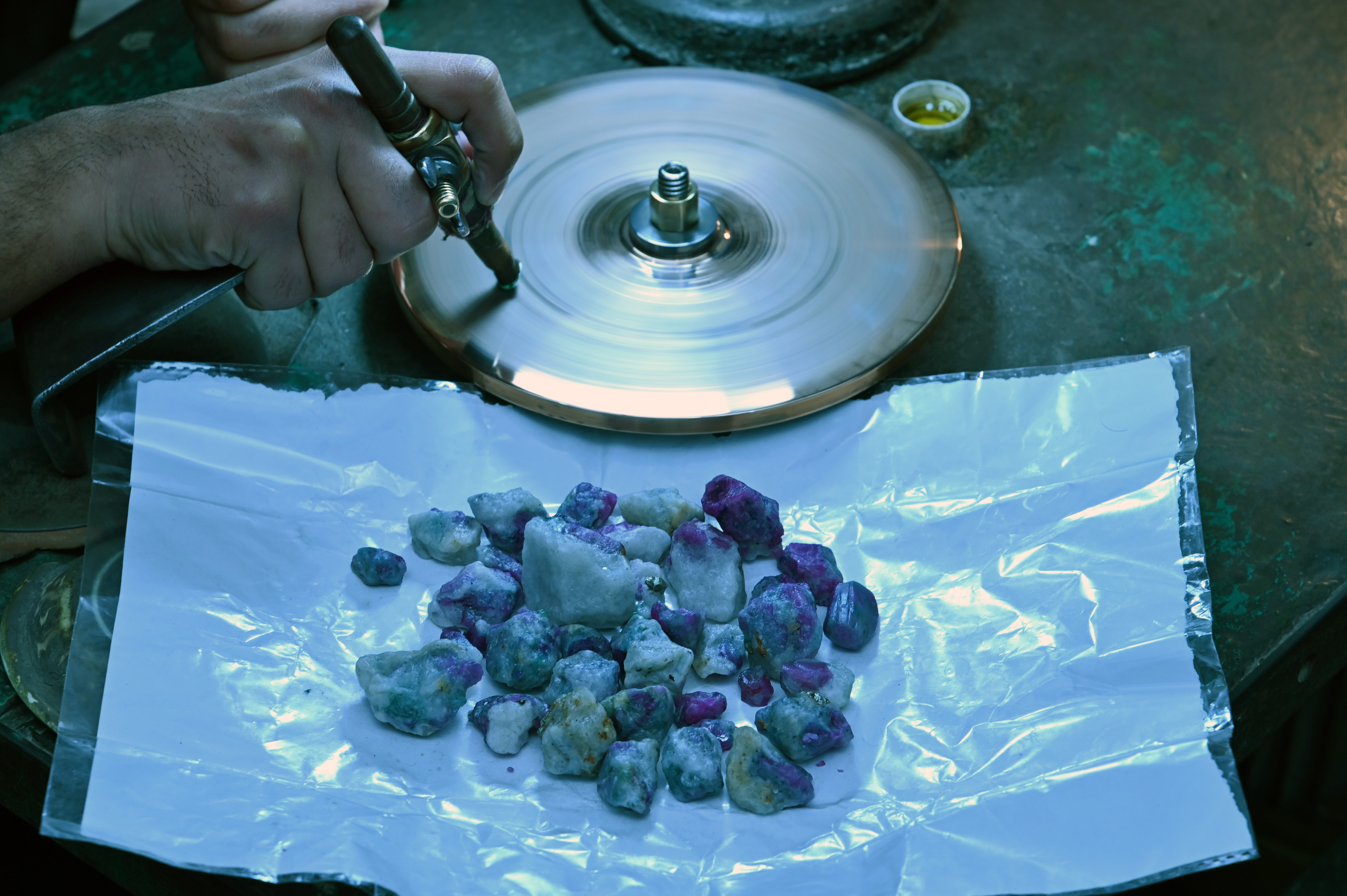 A man busy in refining the stones in the Gems and Crystals Market