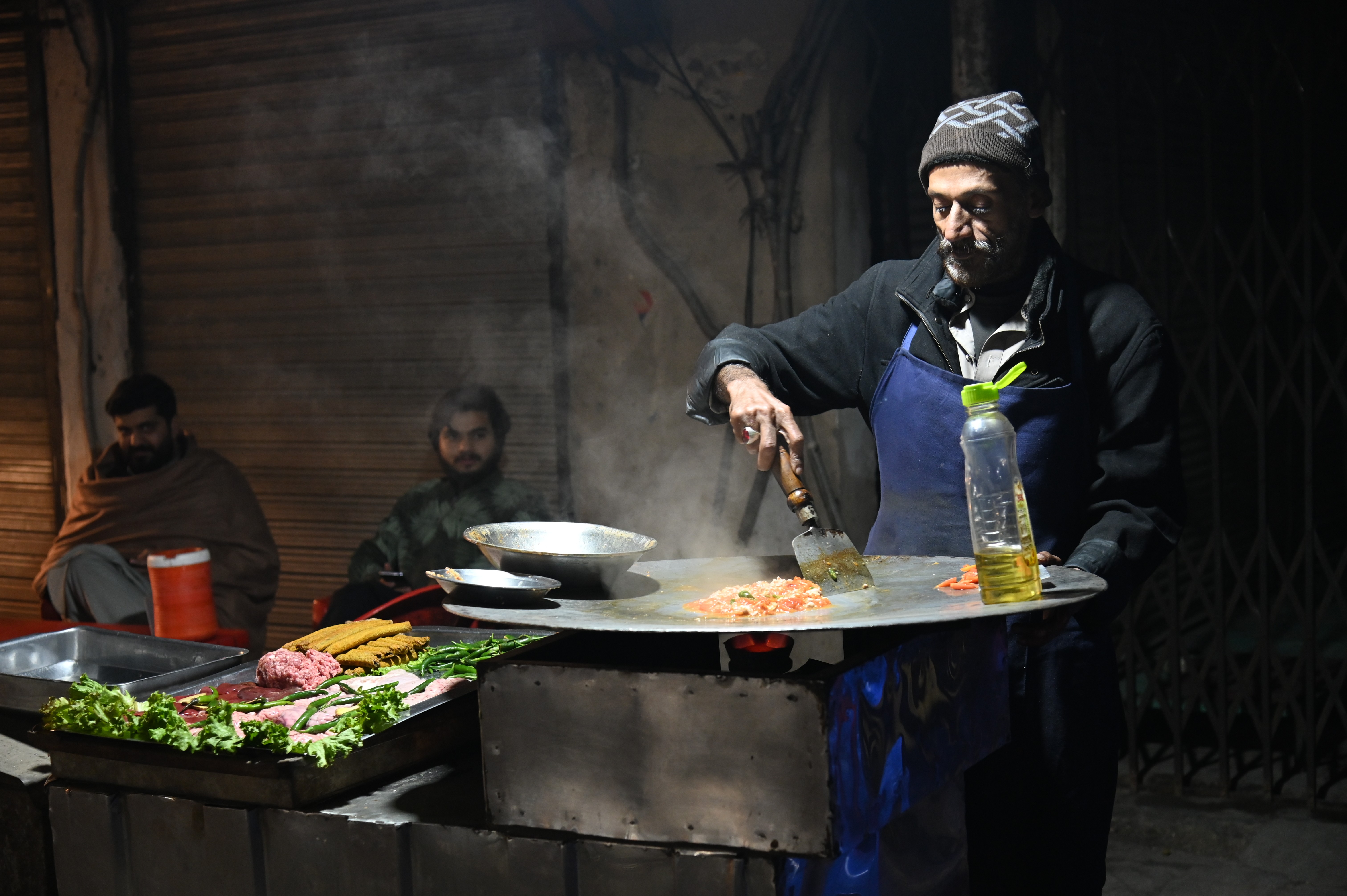 A man selling various varities of Kabab, roasted meat that originates from the Middle East