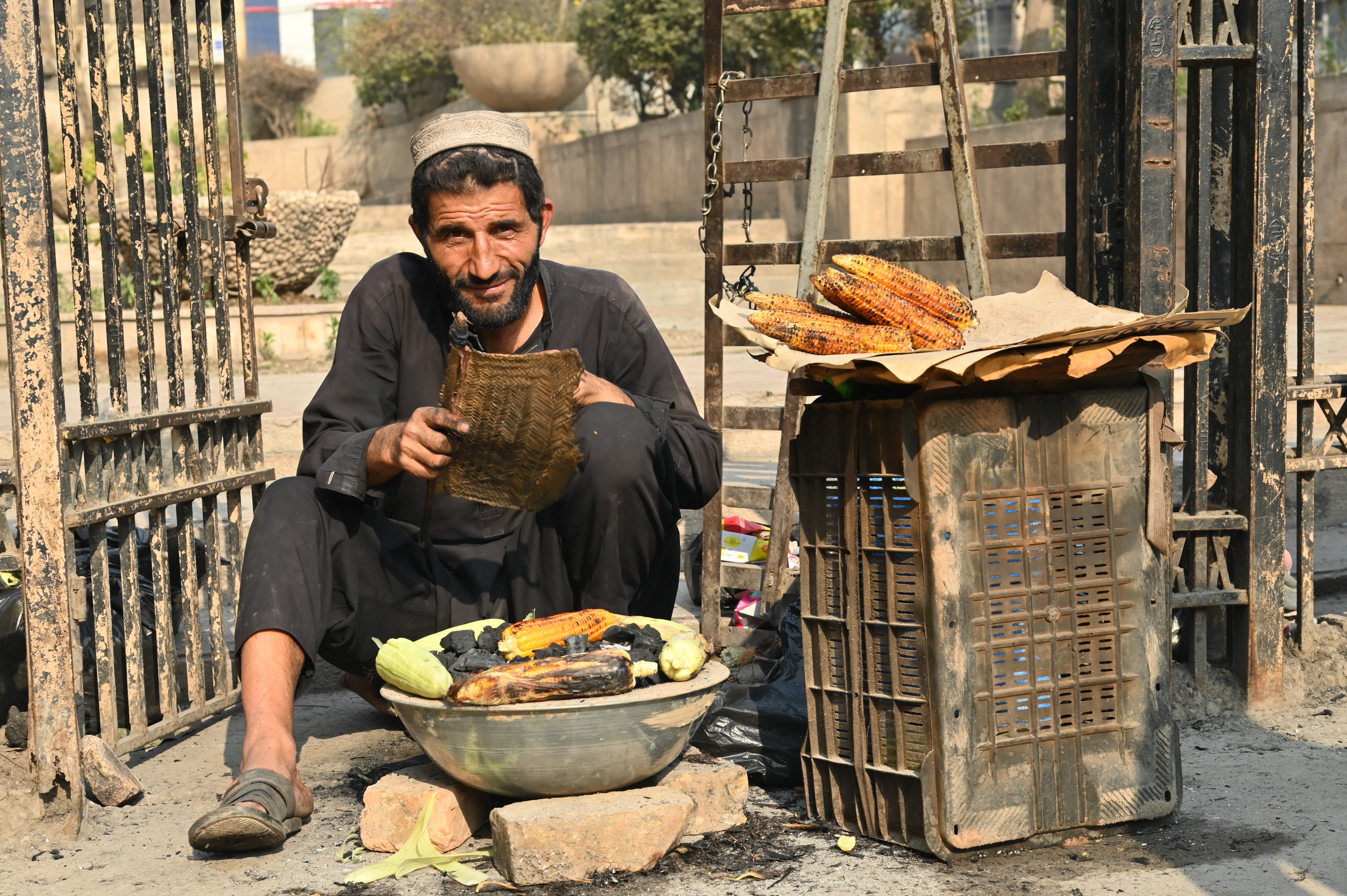 A man selling Bhutta, roasted corn