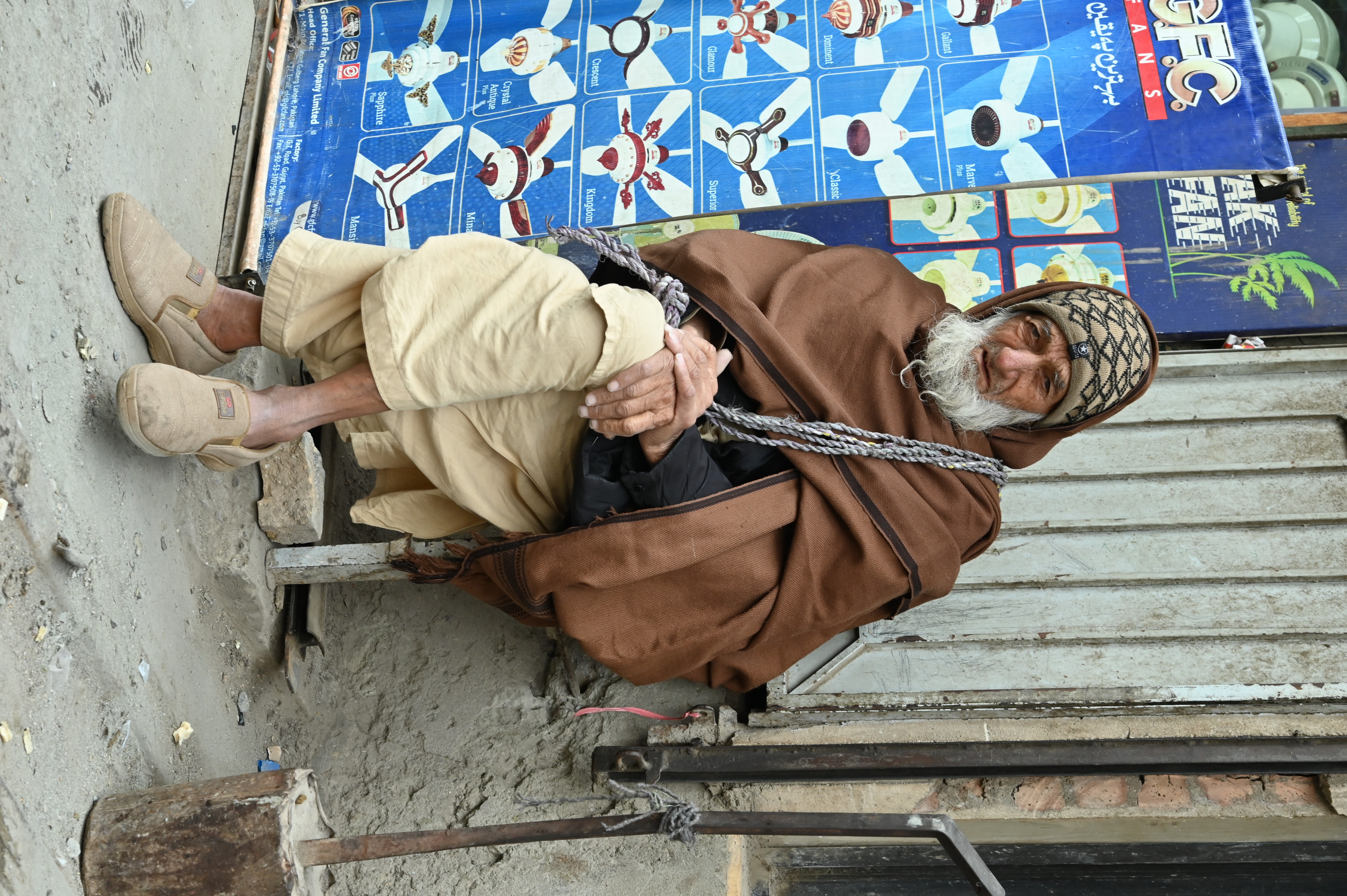 The portrait of an old man wearing warm cloths to protect from extreme cold weather