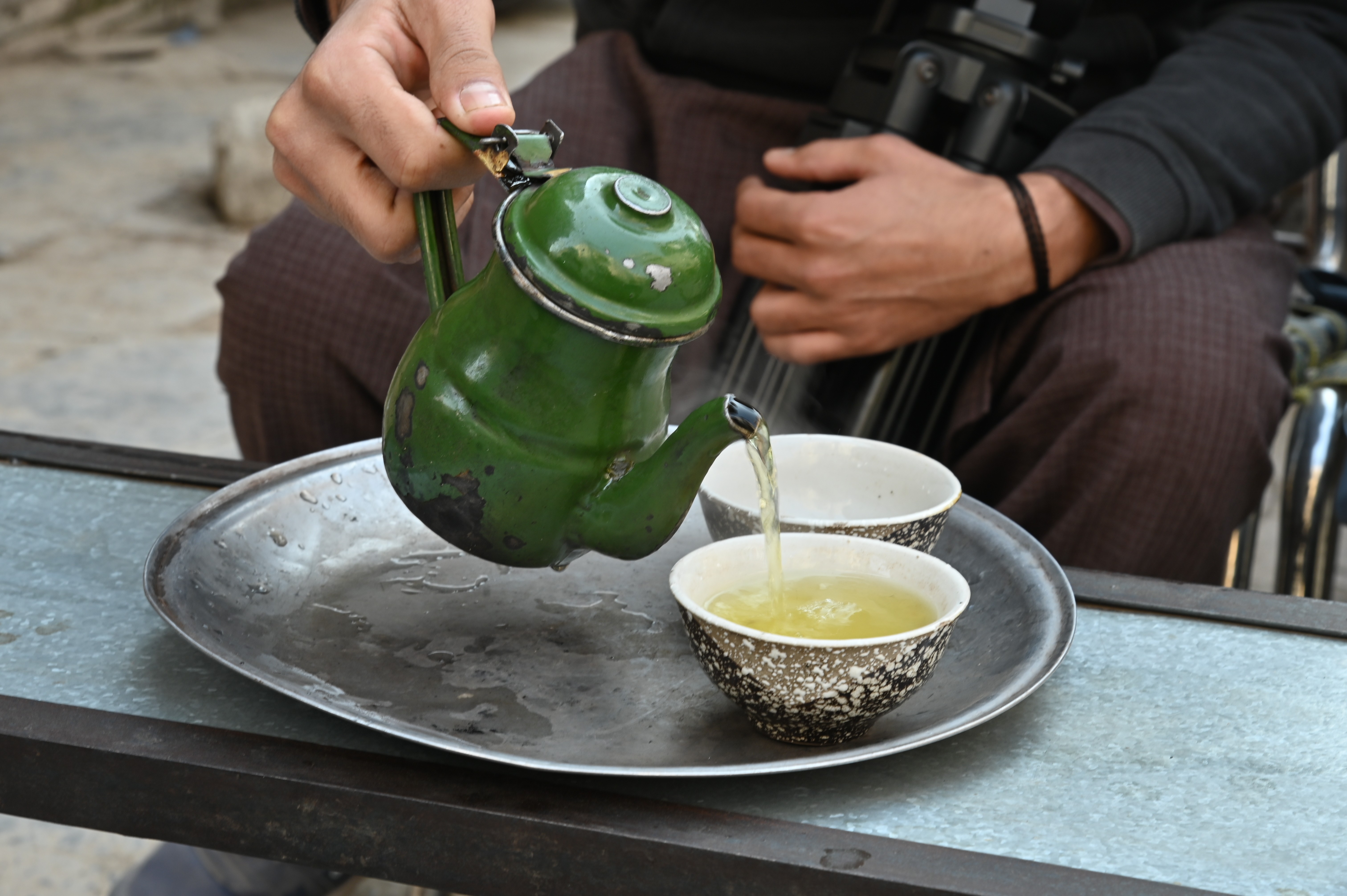 A man having a cup of green tea