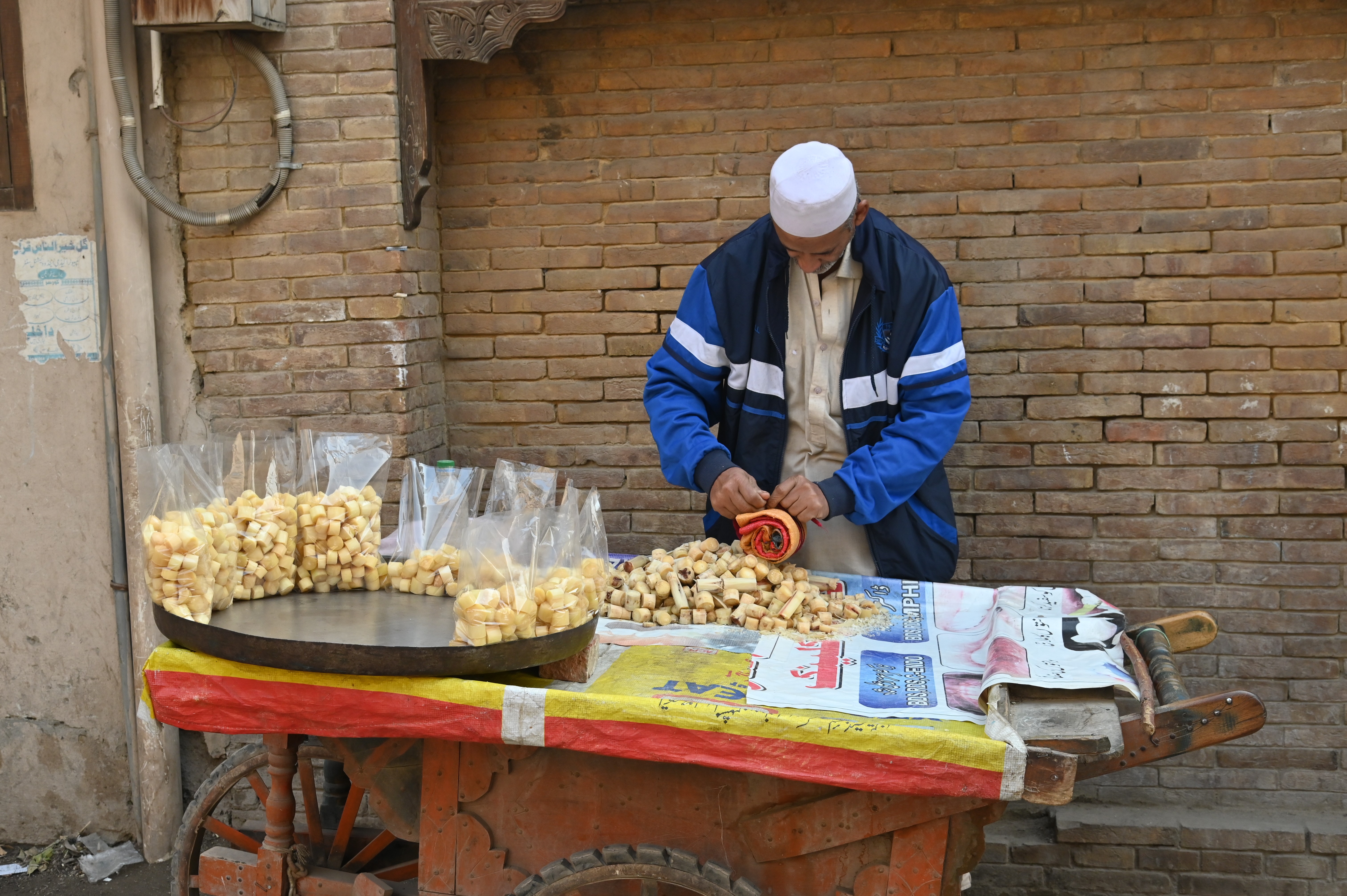 A man packing the pieces of sugar cane to be sold