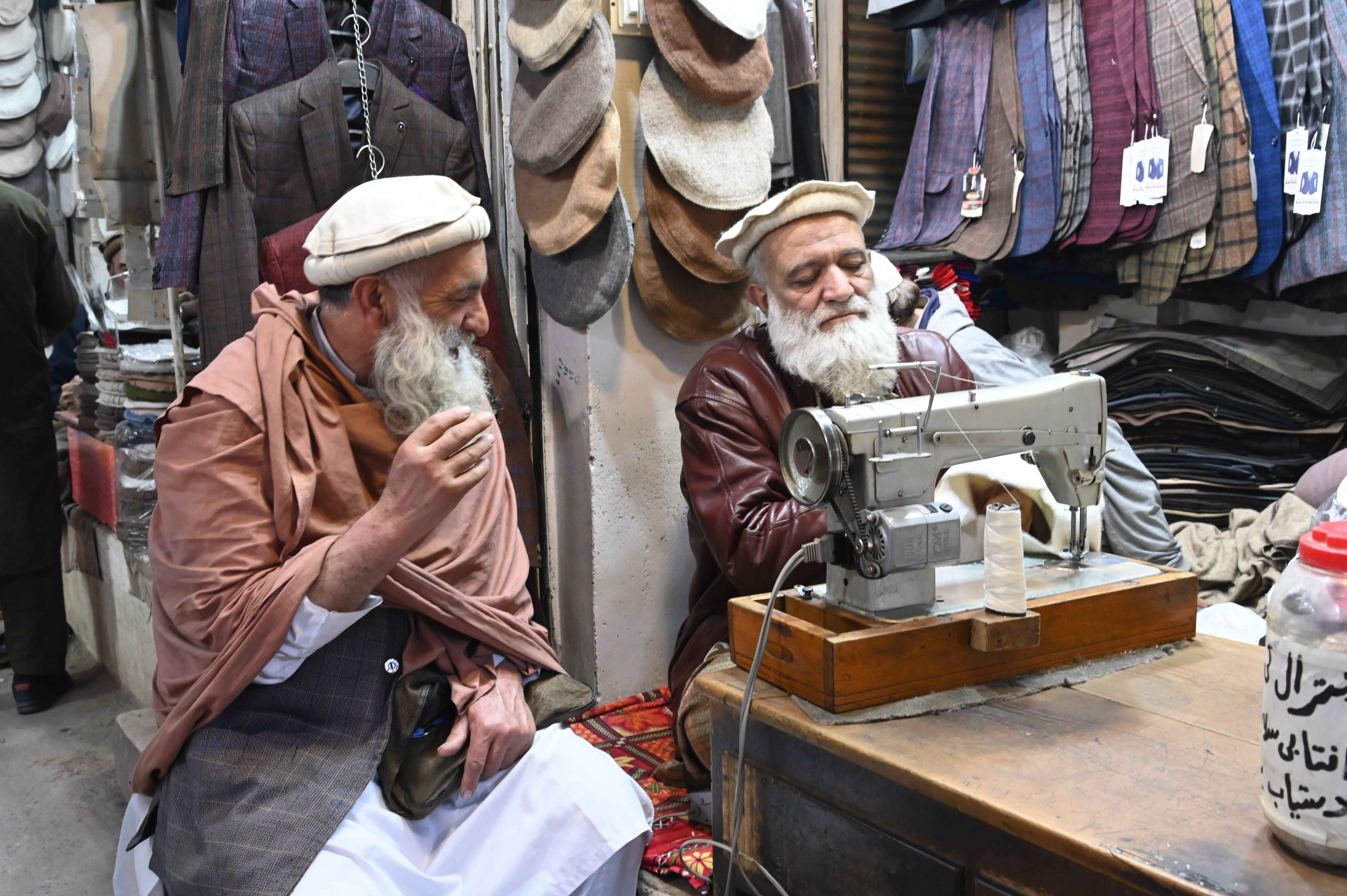 A tailor busy in stitching the warm cloths