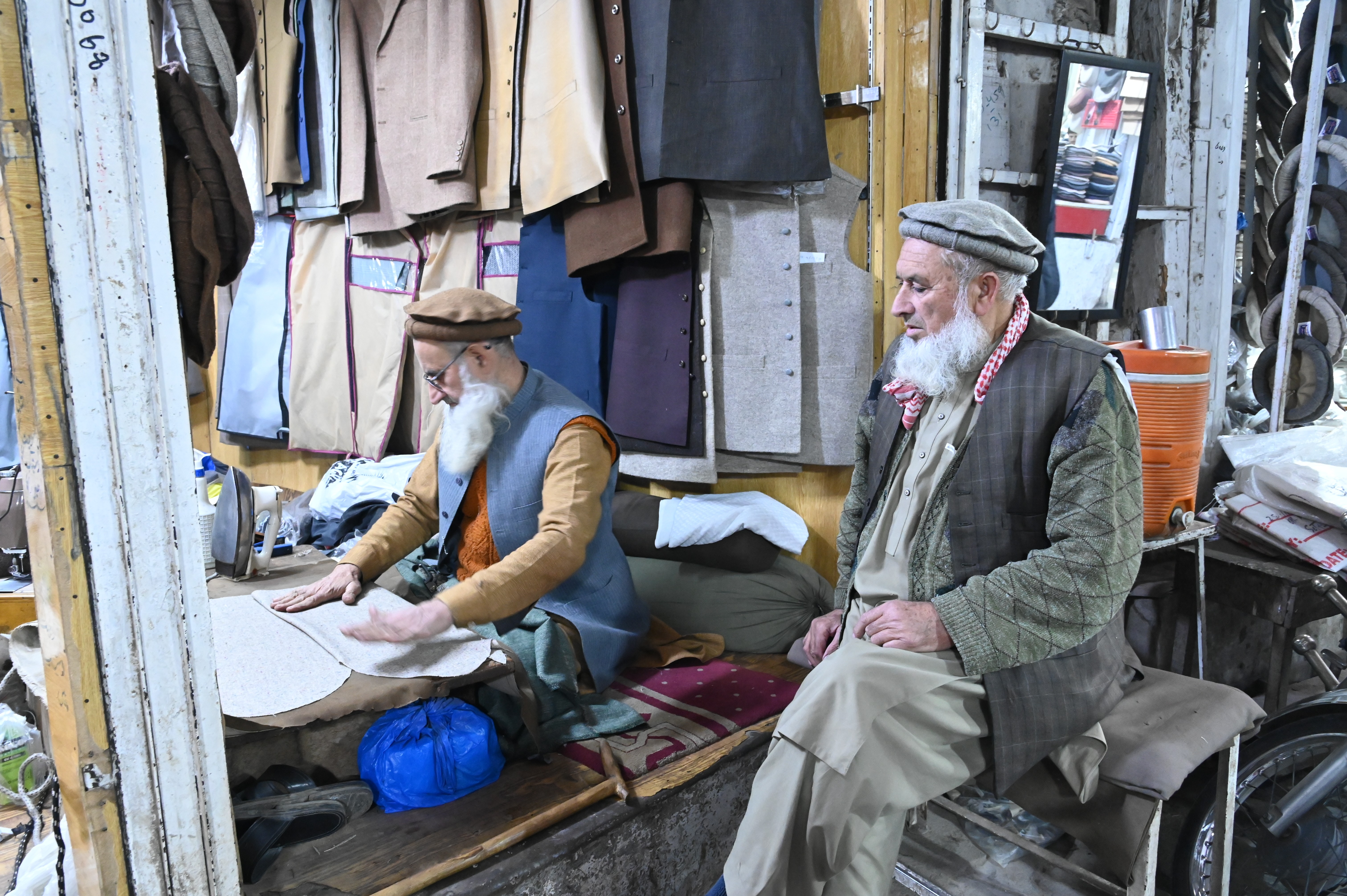 A man alligning pieces of cloths to be sewed