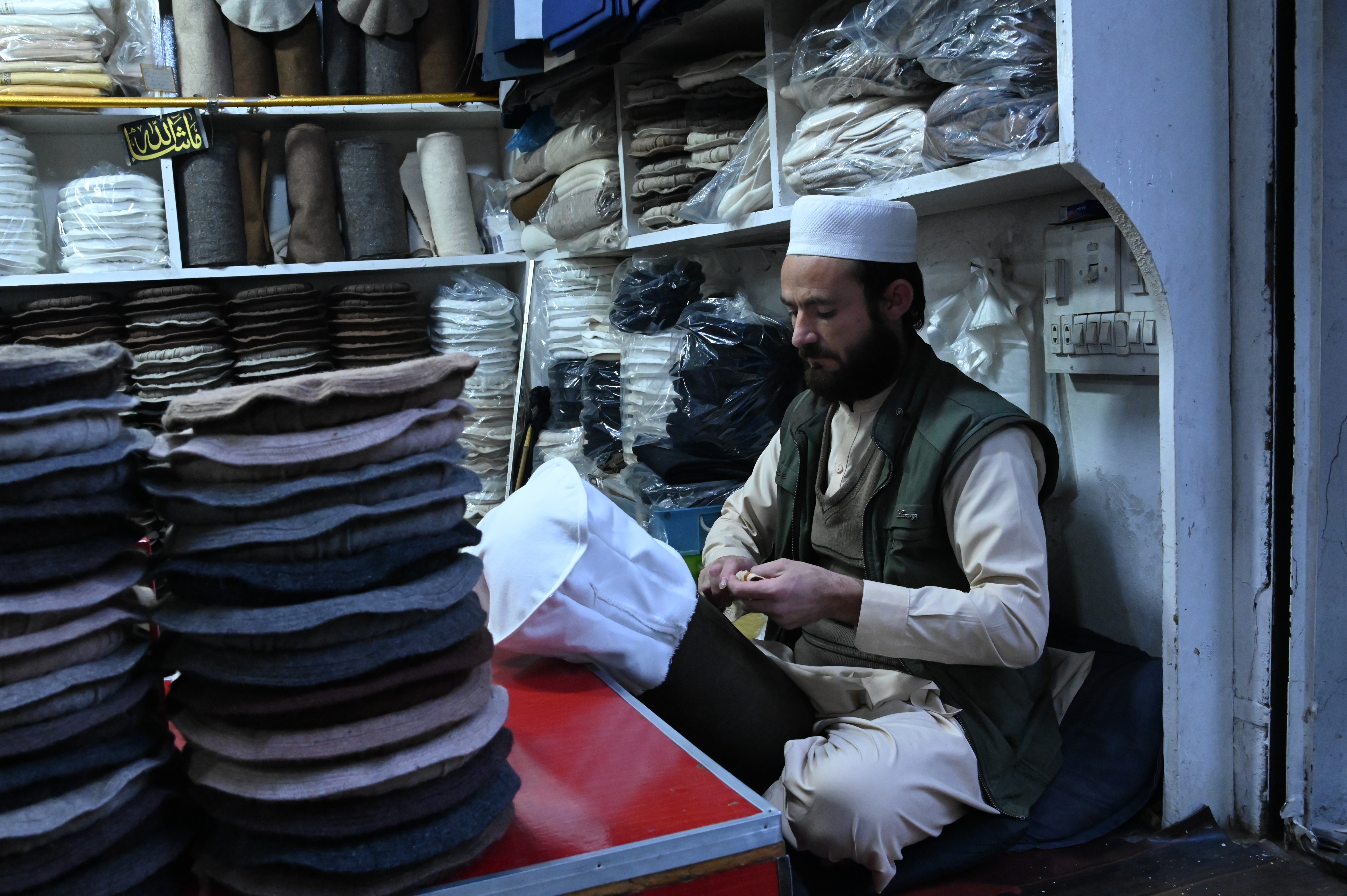 A man selling warm traditional caps