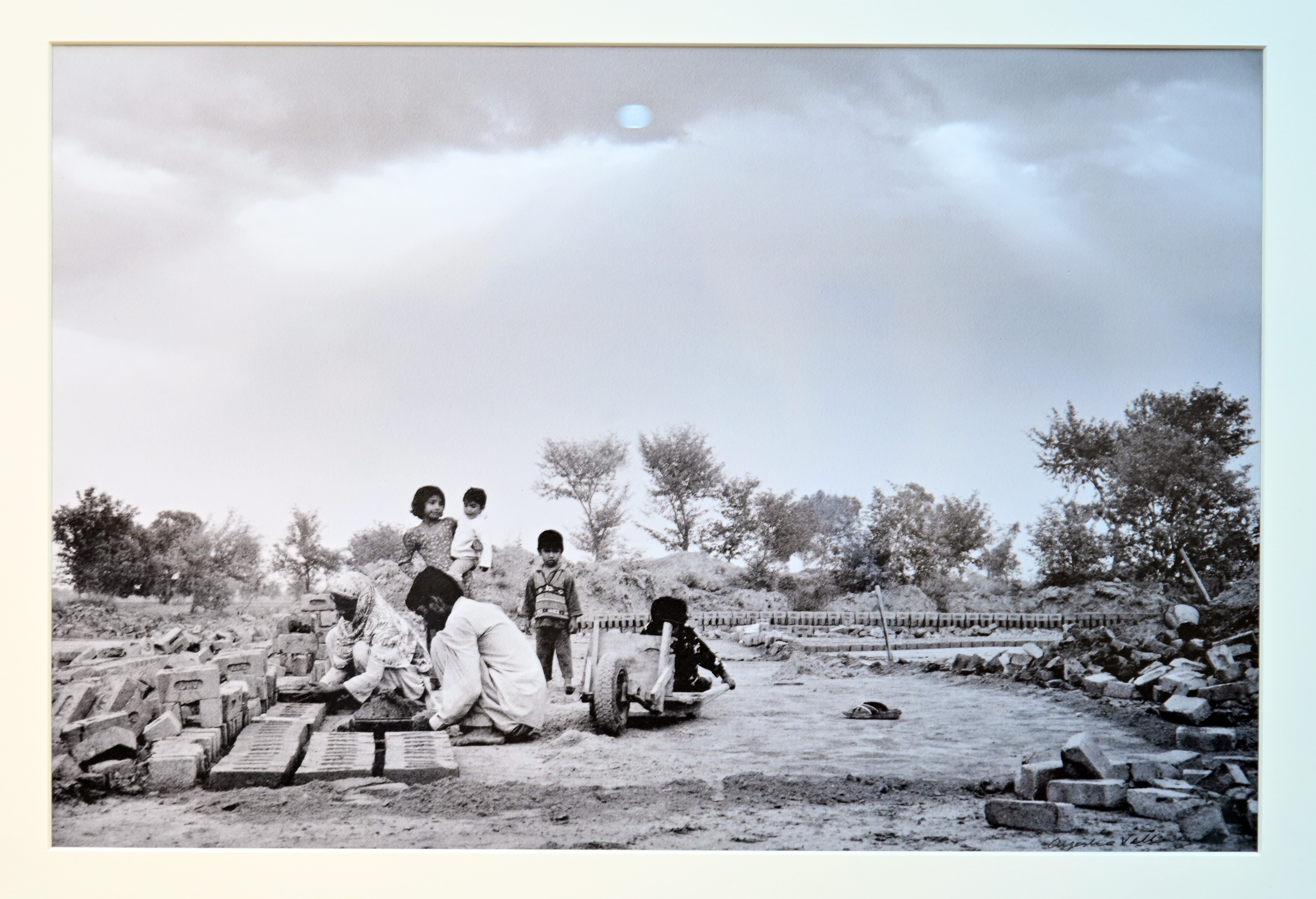 A picture depicting a family busy in making bricks