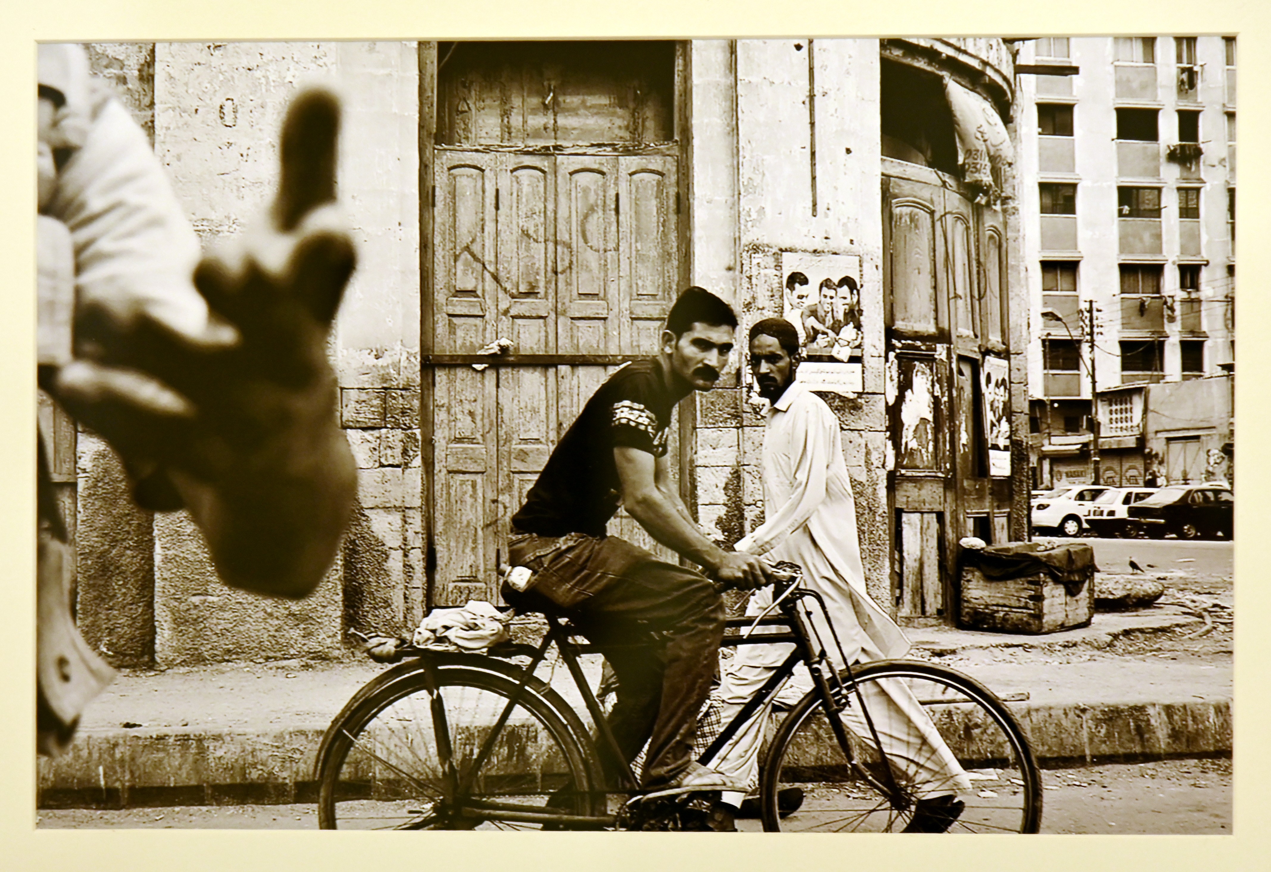 A photograph of a man passing by the street