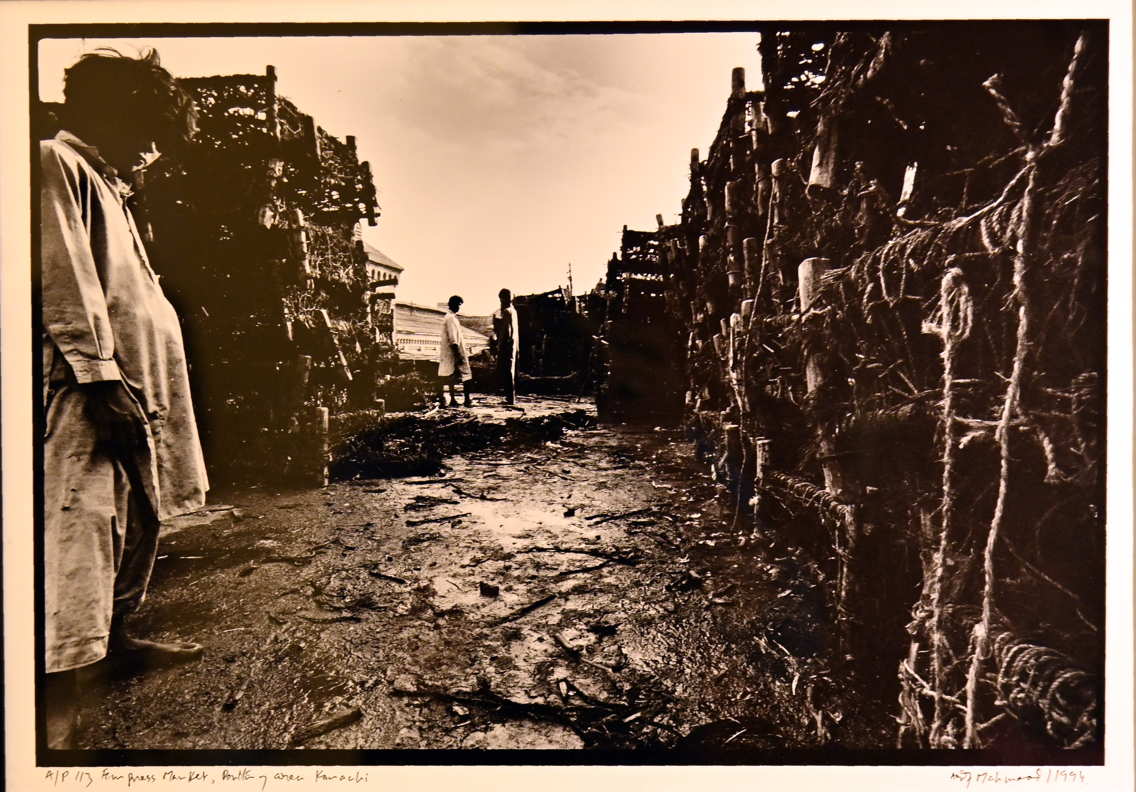 A photograph of men near Charpai frames