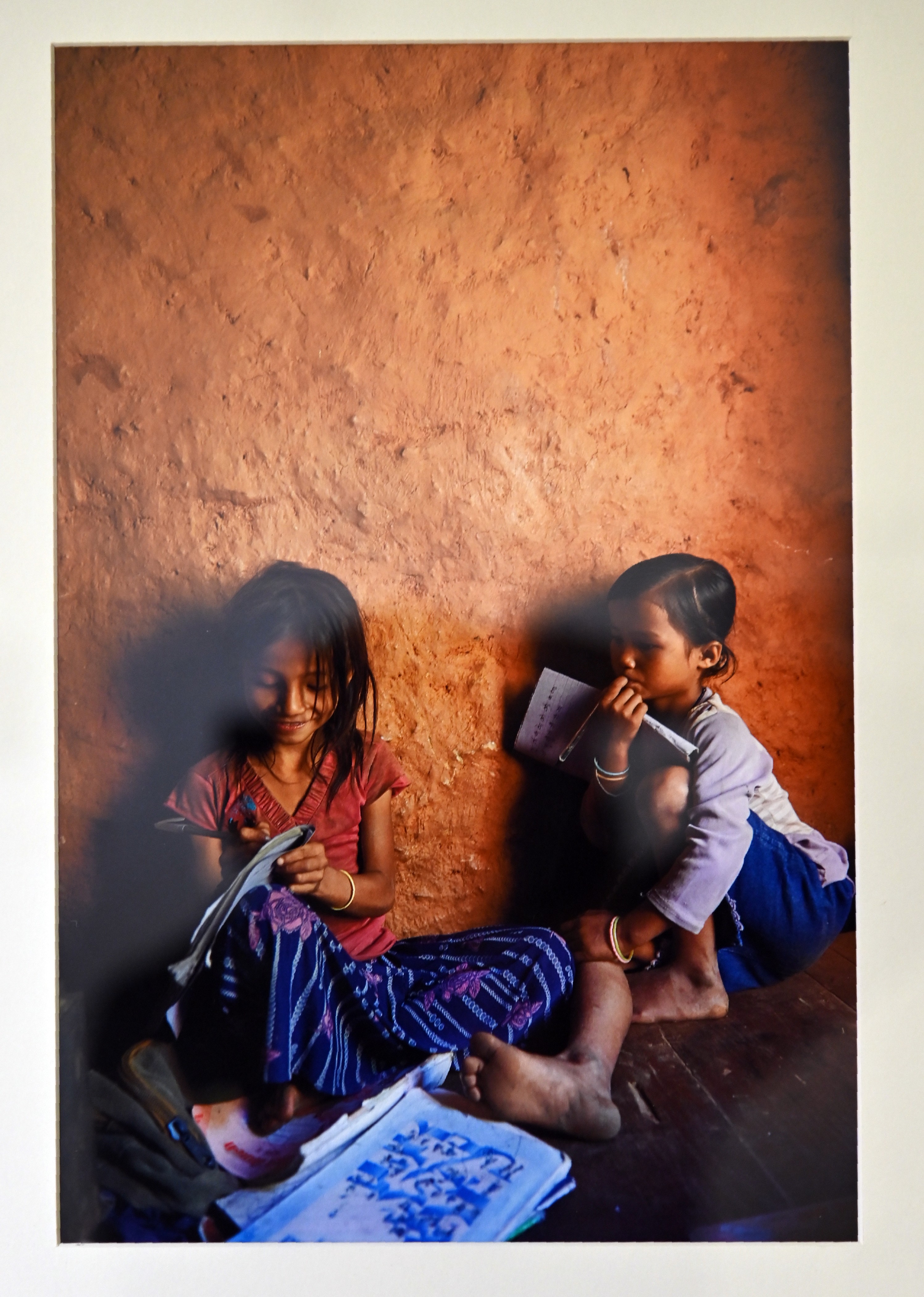 Two little girls busy in studying