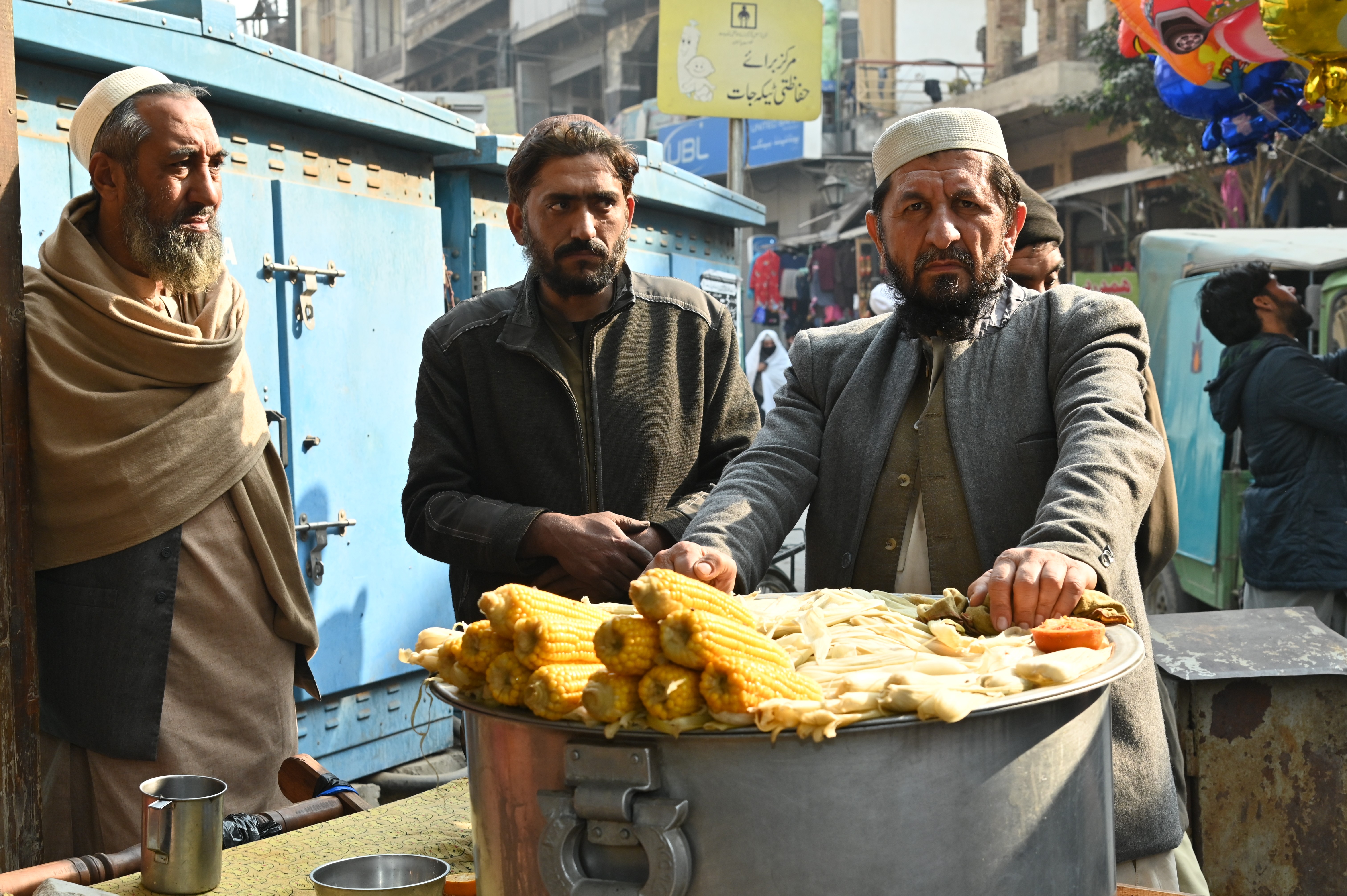 A boy selling boiled corn