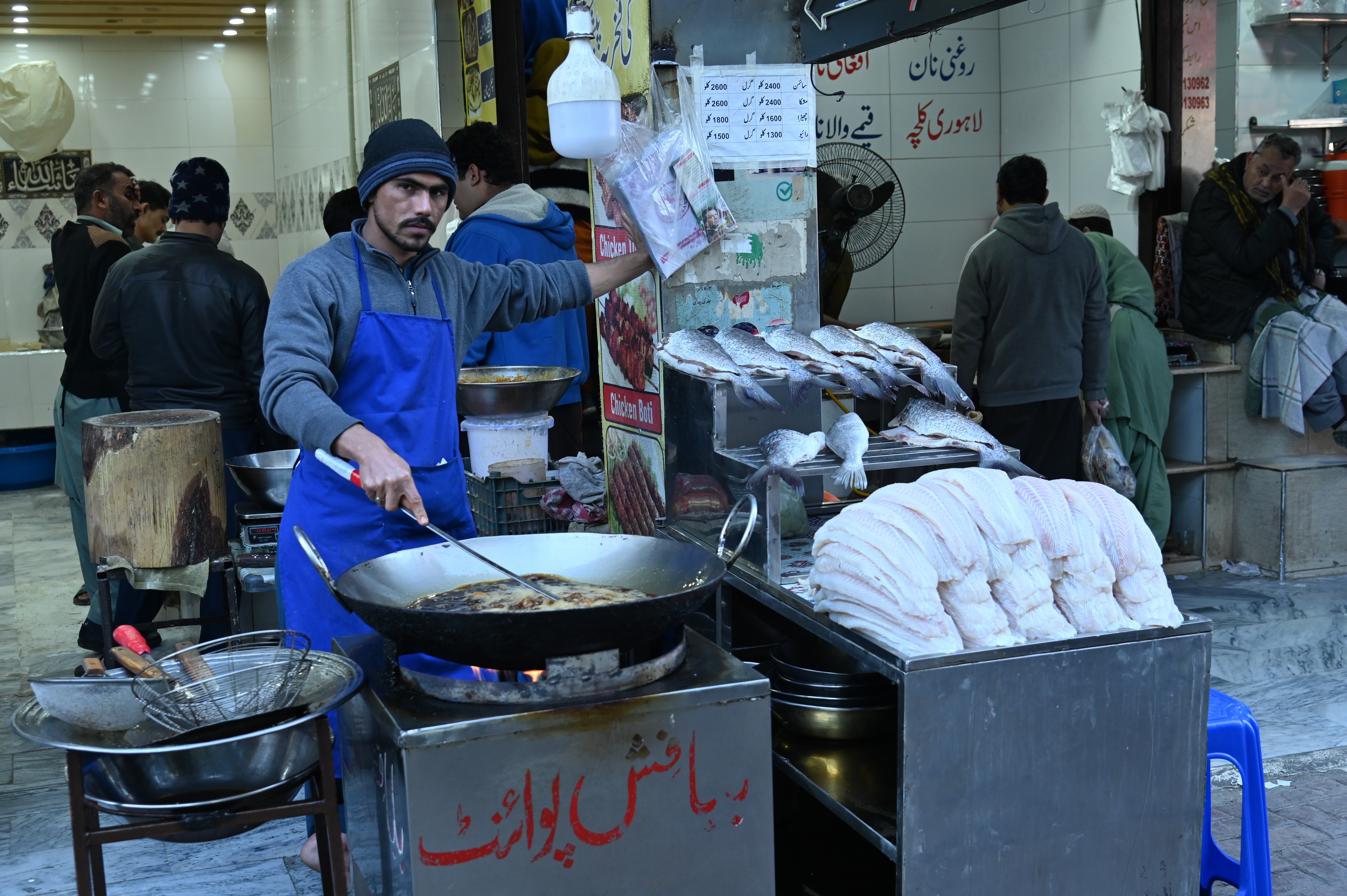 A man selling fried fish