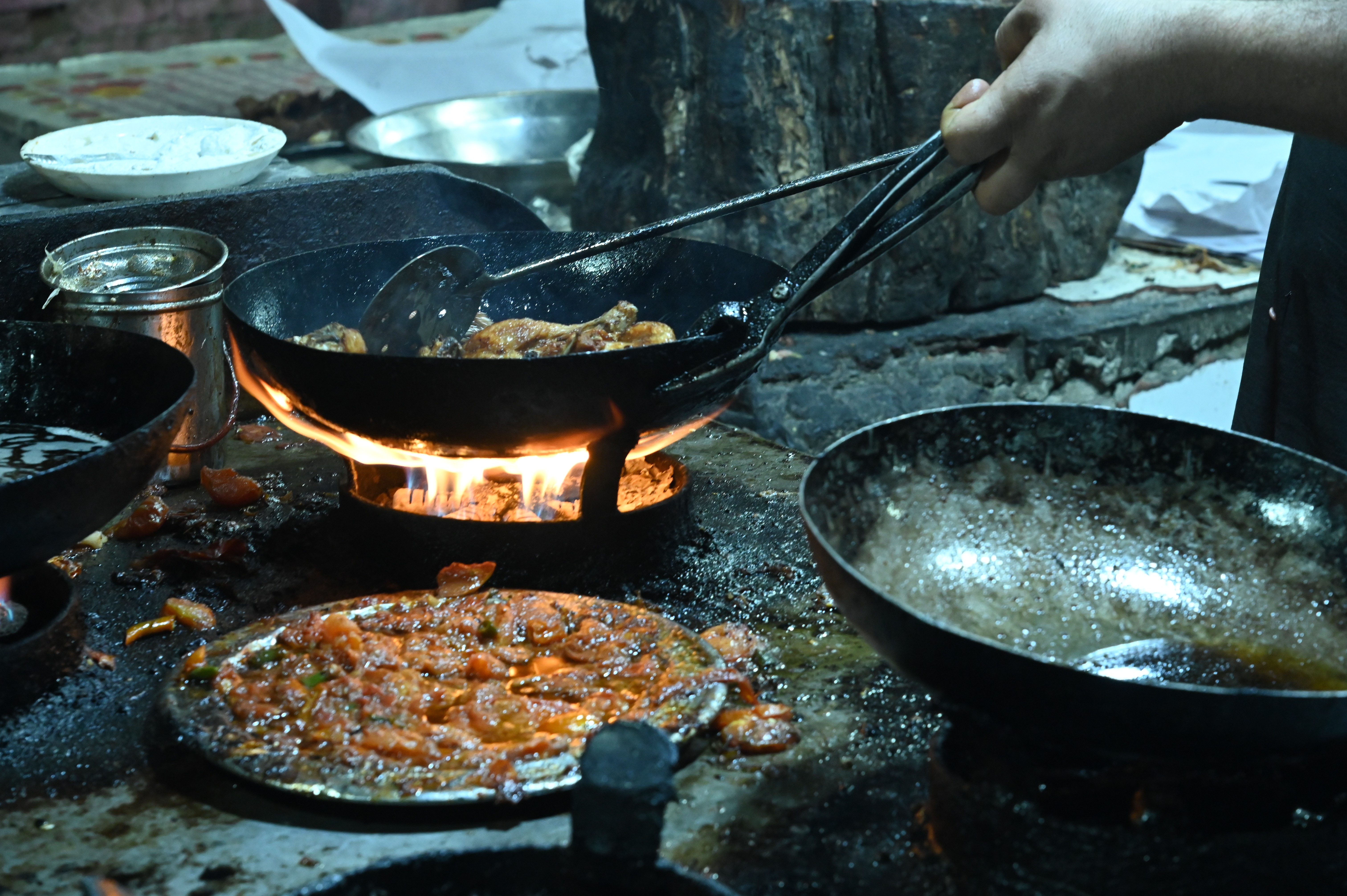 A chef busy in cooking Chicken Karahi