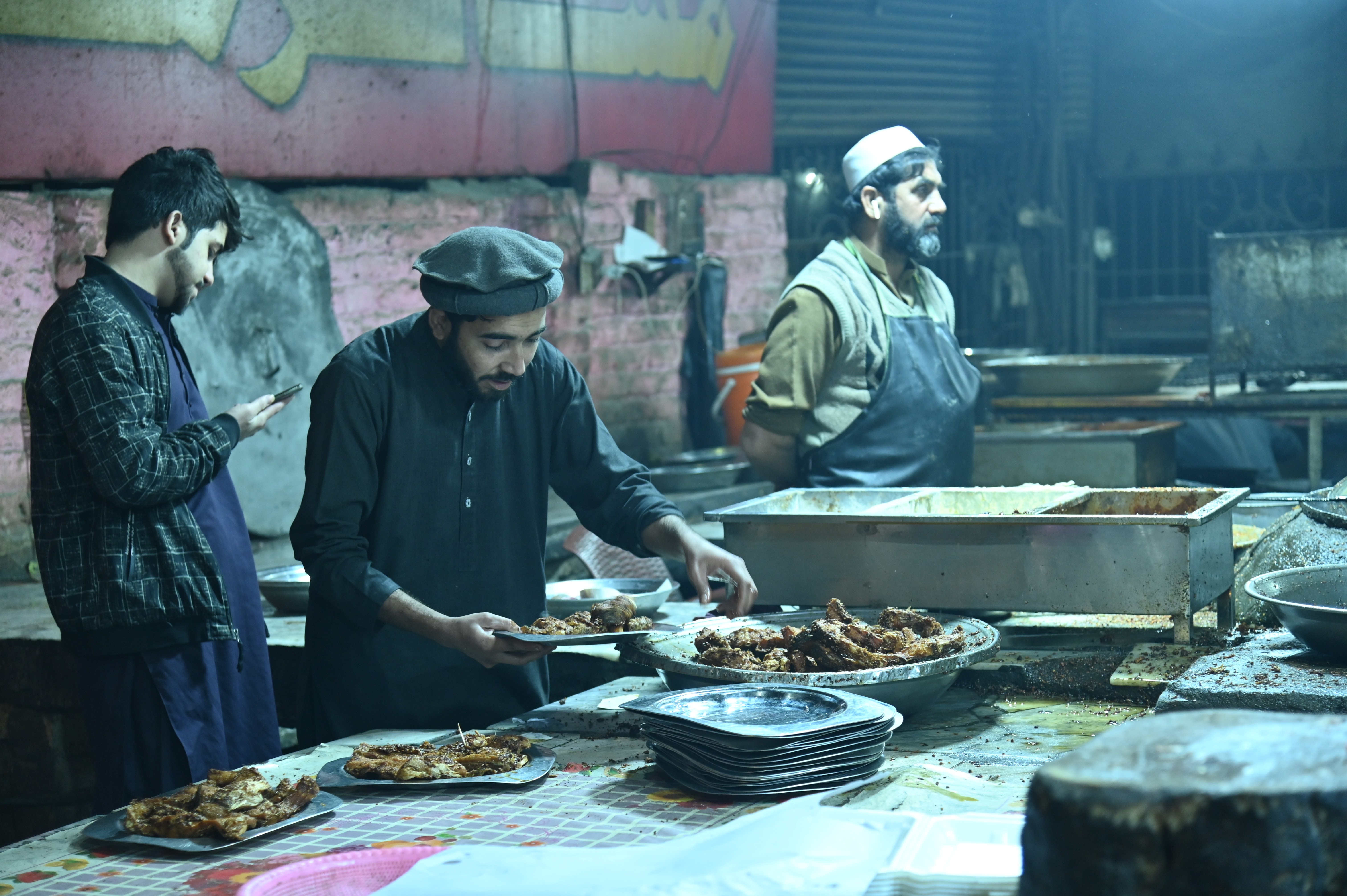 The waiter busy in serving fried fish