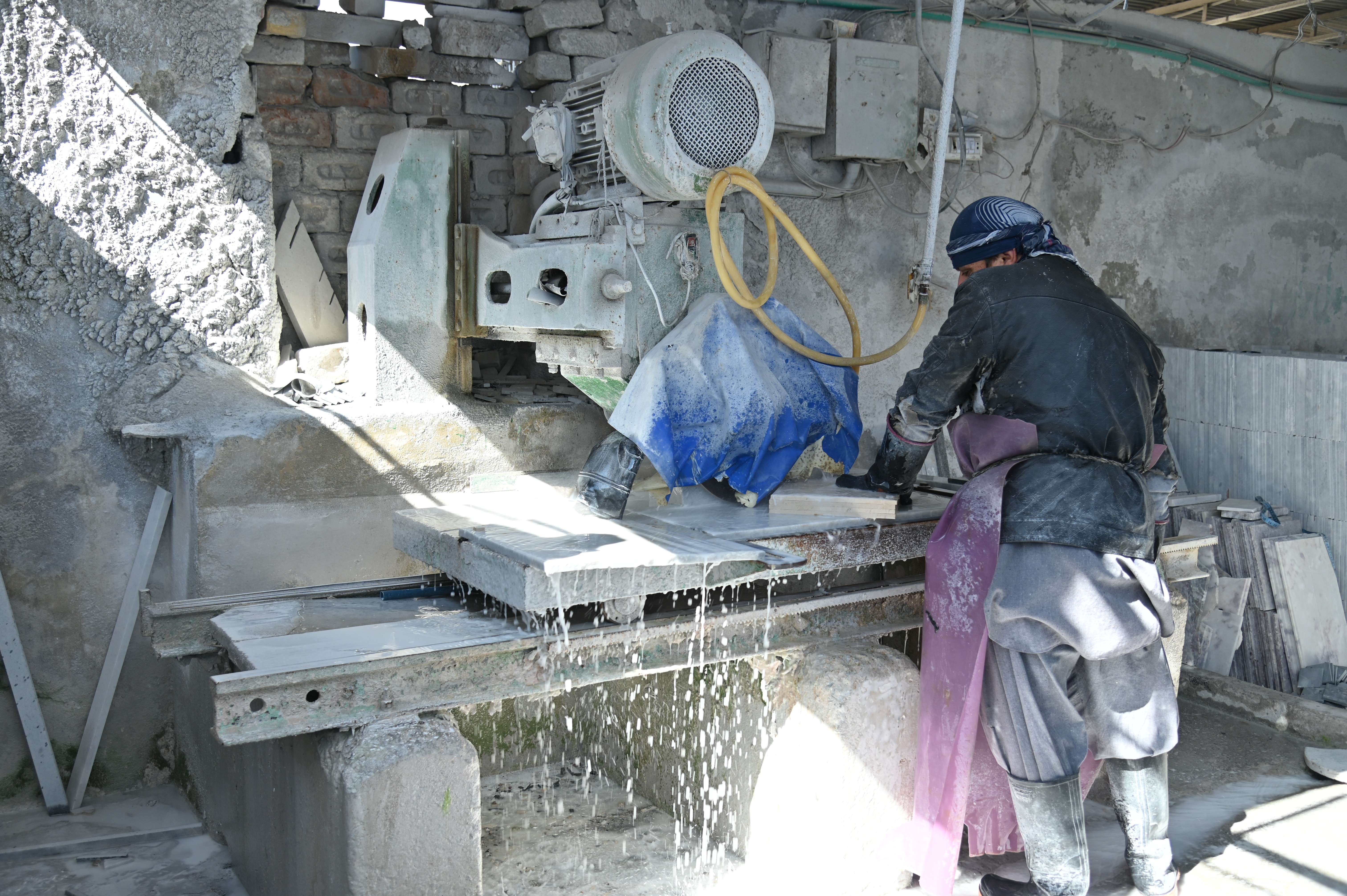 A man cutting a marble