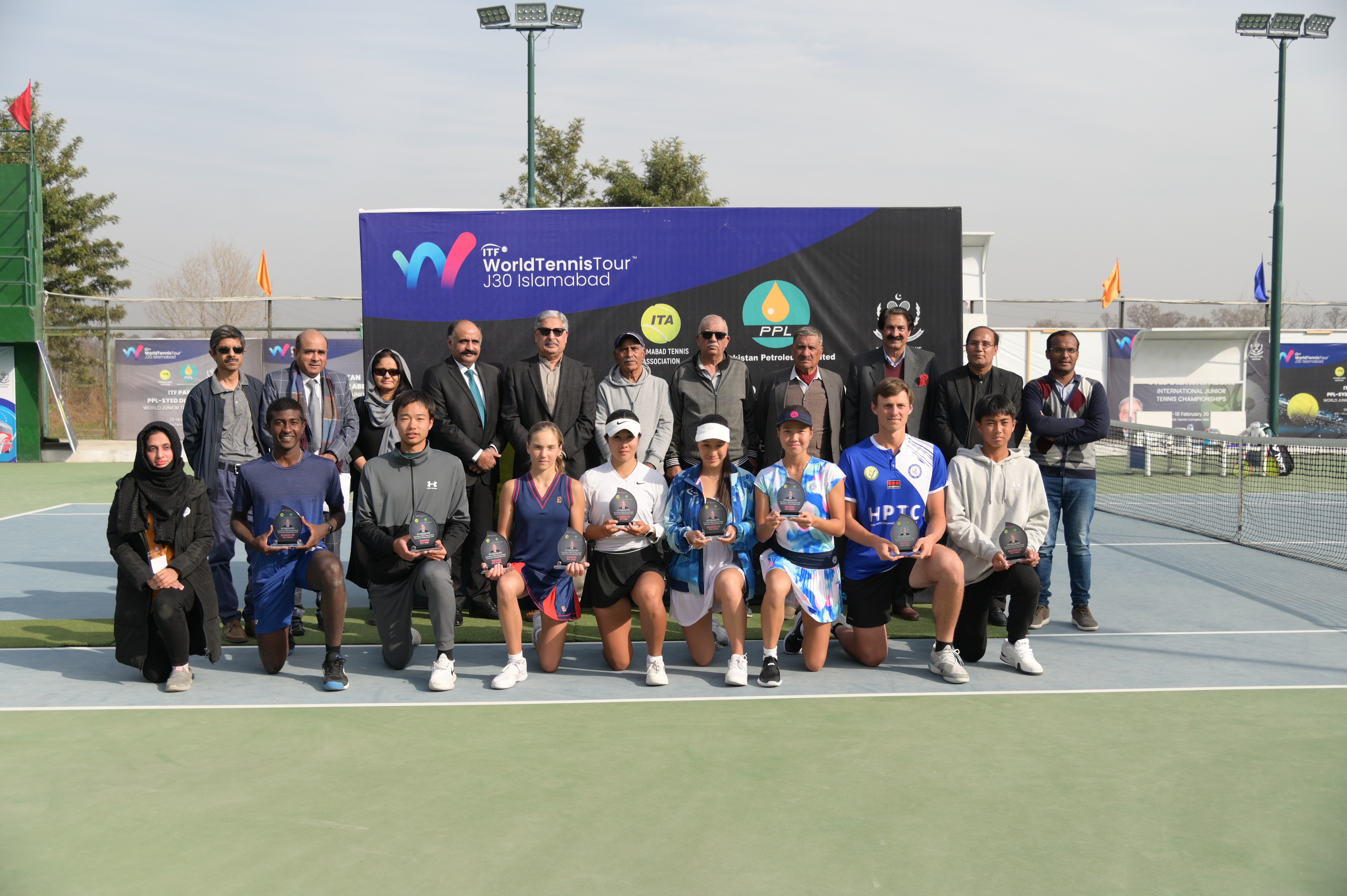 A group photo of winning tennis players