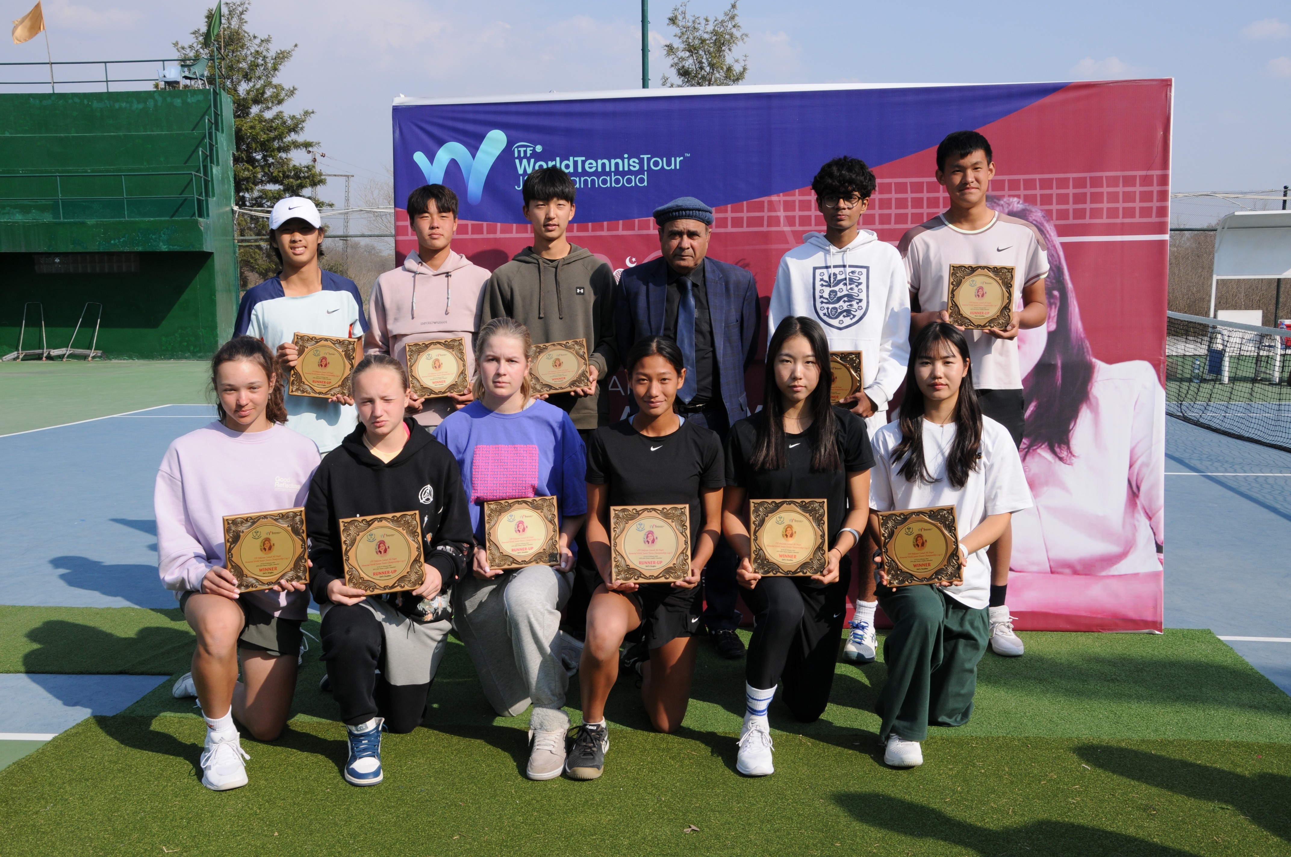 A group photo of winning tennis players