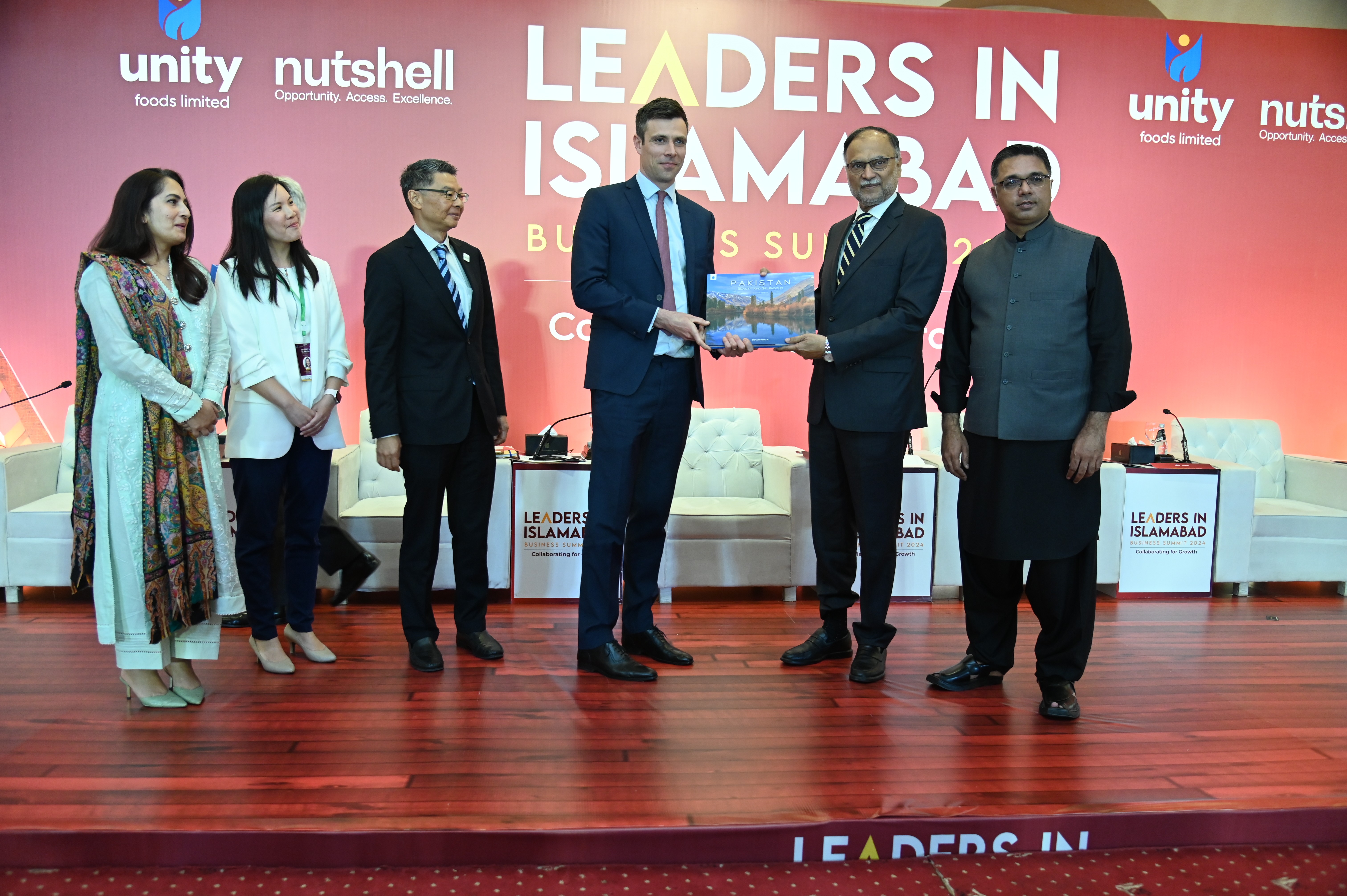 Prof. Ahsan Iqbal, The Federal Minister presenting a handbook of Pakistan to Philip Skinner, Managing Director at GuarantCo Impact Investing