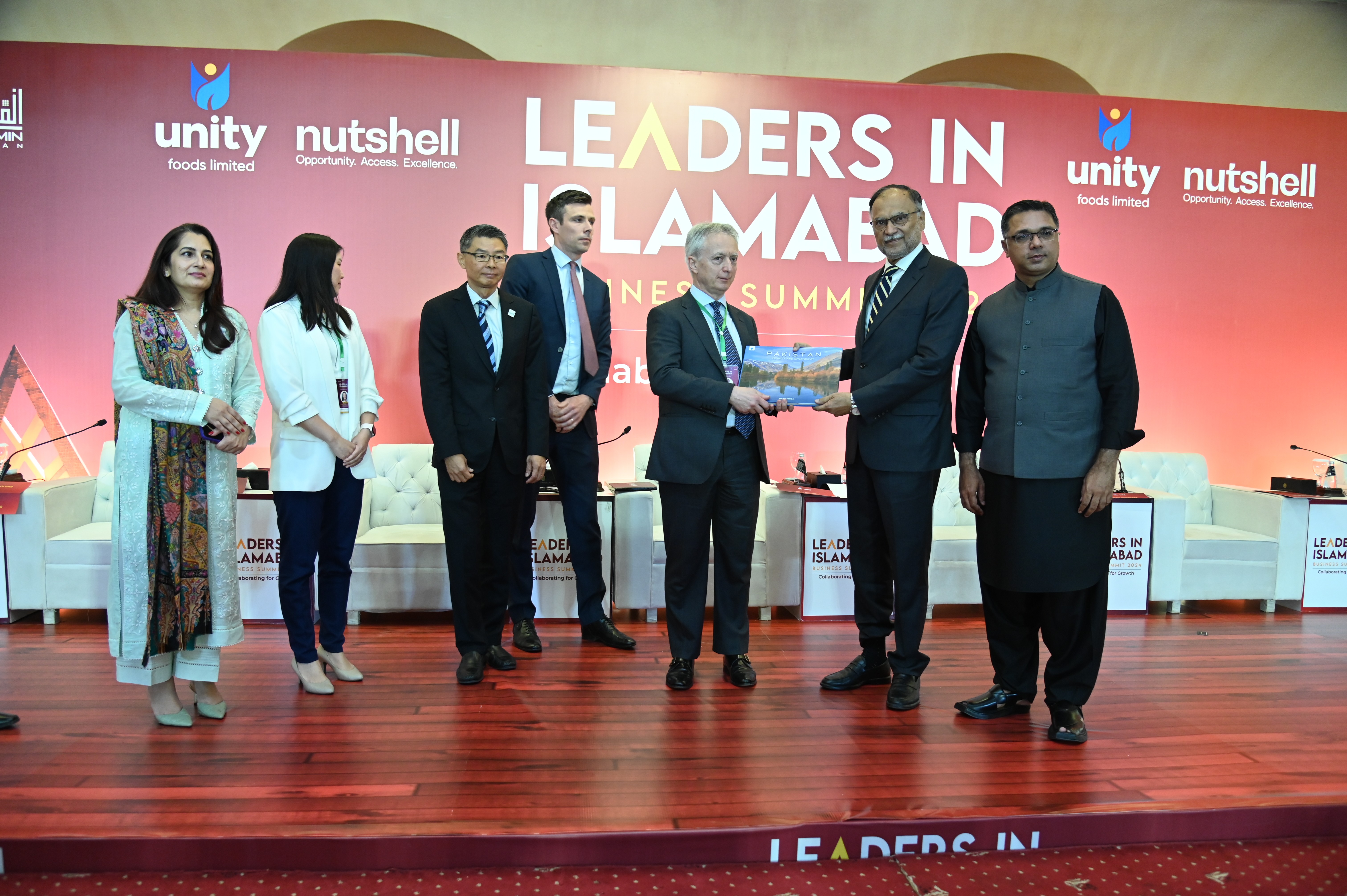 Prof. Ahsan Iqbal, The Federal Minister presenting a handbook of Pakistan to Emilio Cattaneo, Head of Technical Assistance,PIDG