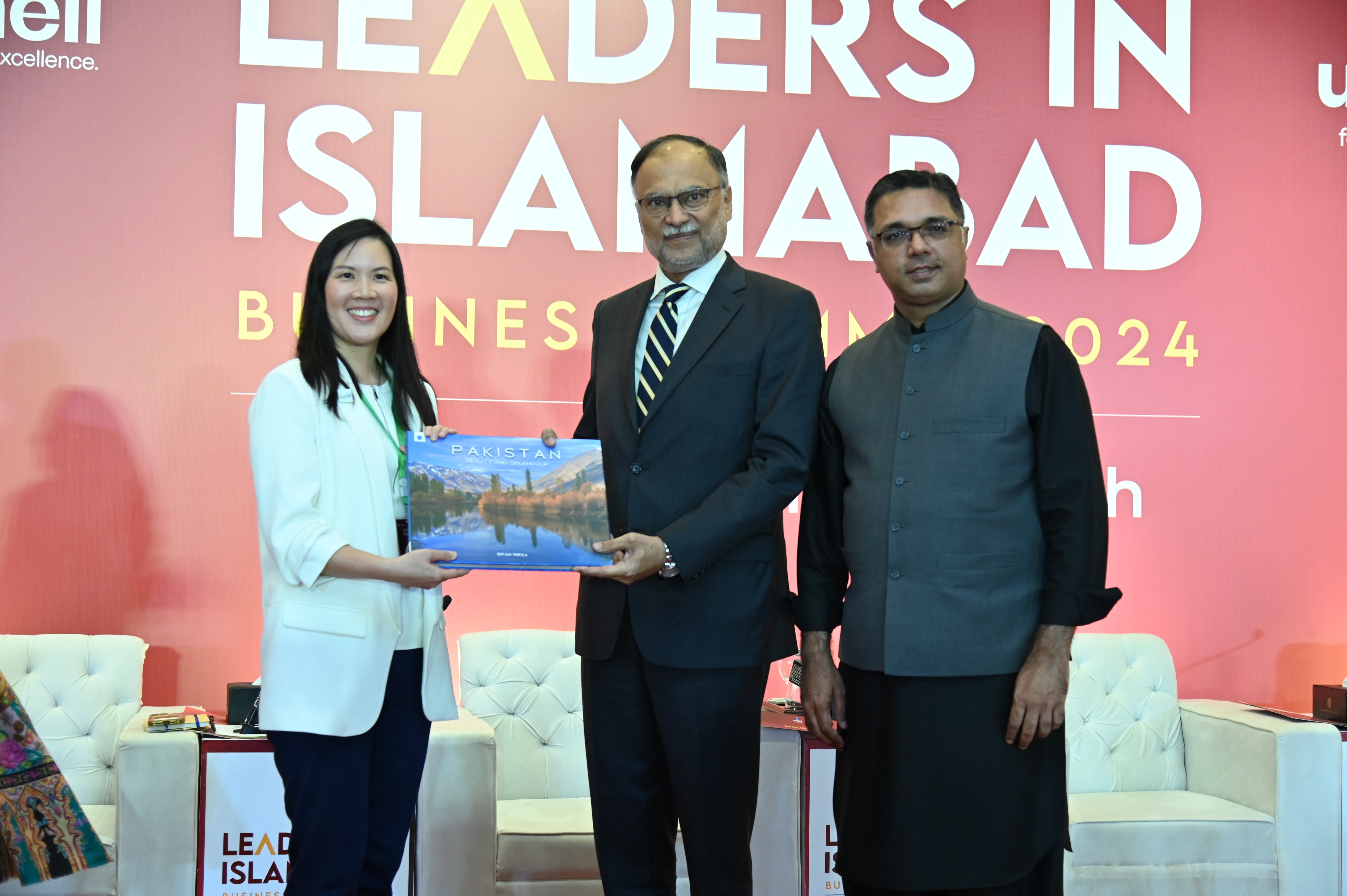 Prof. Ahsan Iqbal, The Federal Minister presenting a handbook of Pakistan to Ms Karen Tsang Hounsell