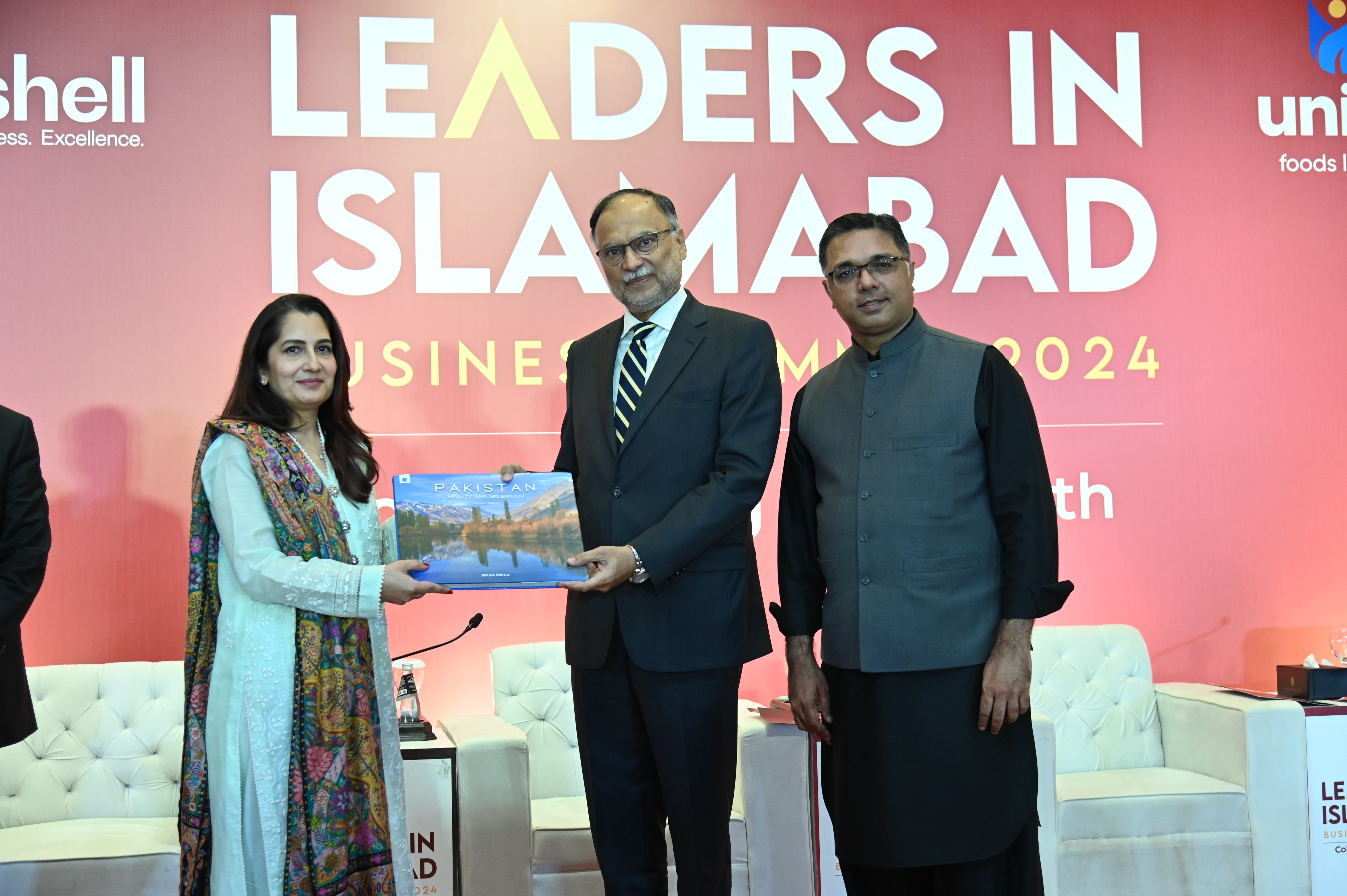 Prof. Ahsan Iqbal, The Federal Minister presenting a handbook of Pakistan to Ms Maheen Rehman