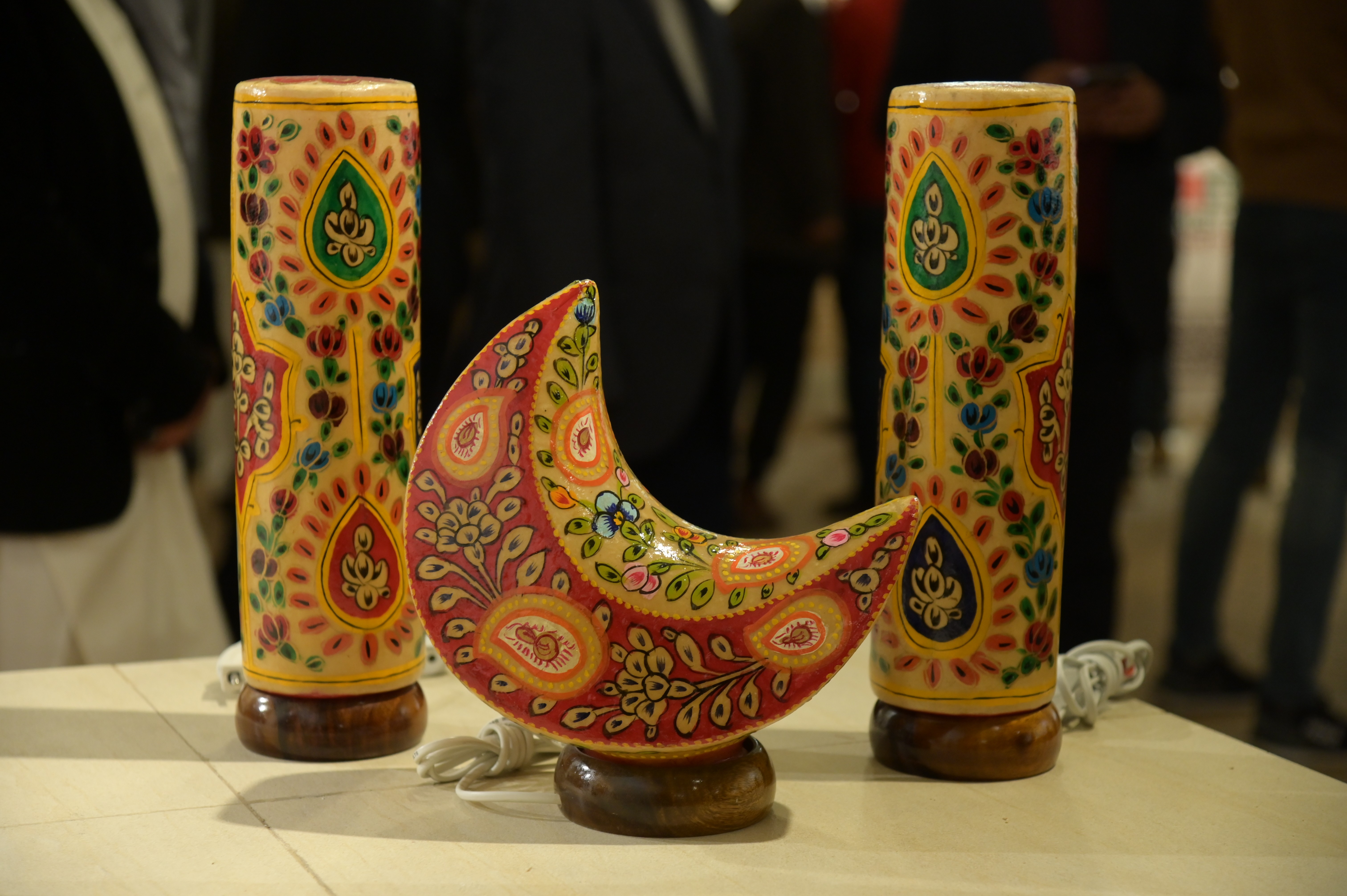 A crescent-shaped decorative piece with vibrant floral patterns