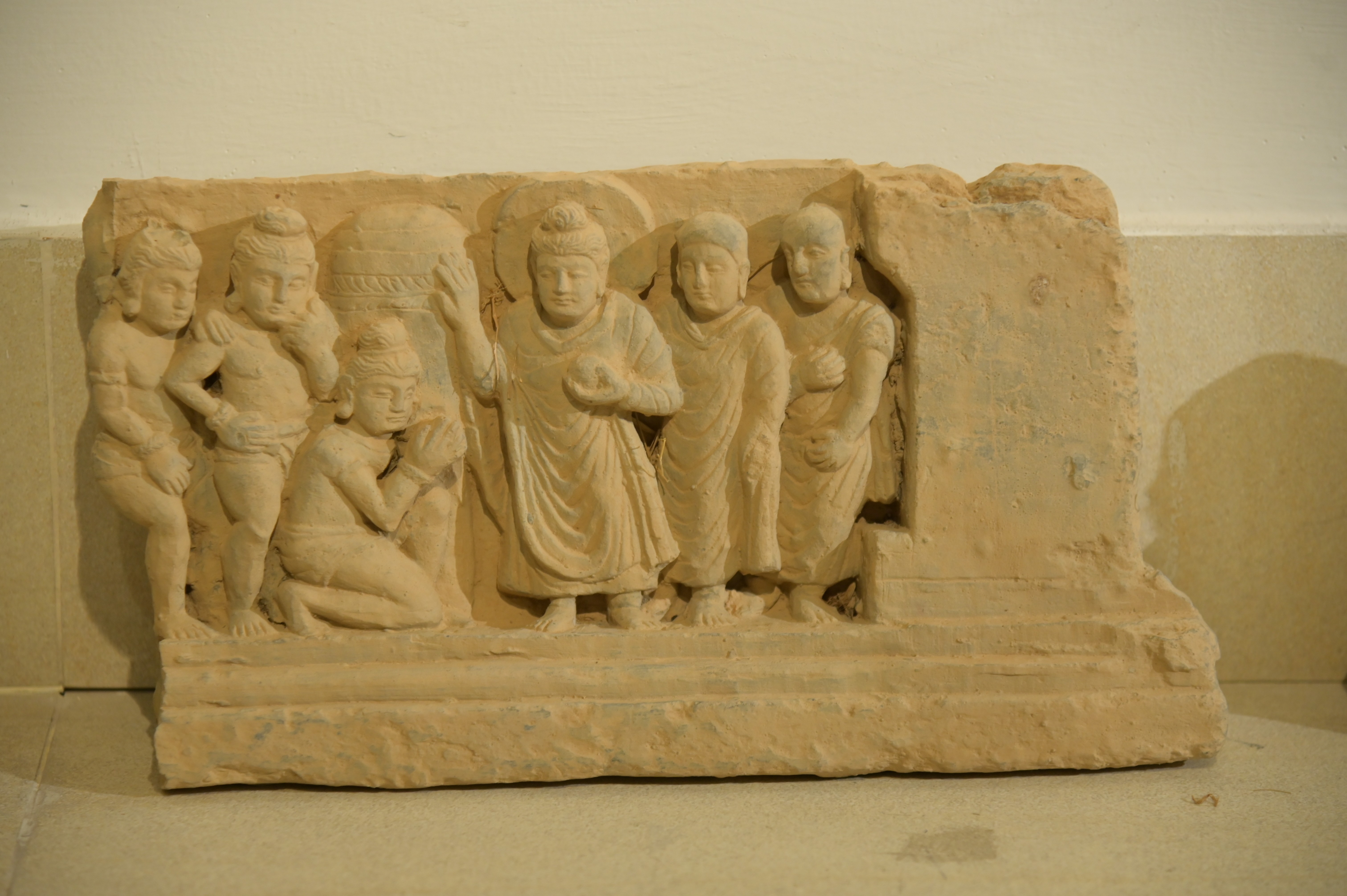 Ancient Gandhara-era stone carving depicting a historical scene
