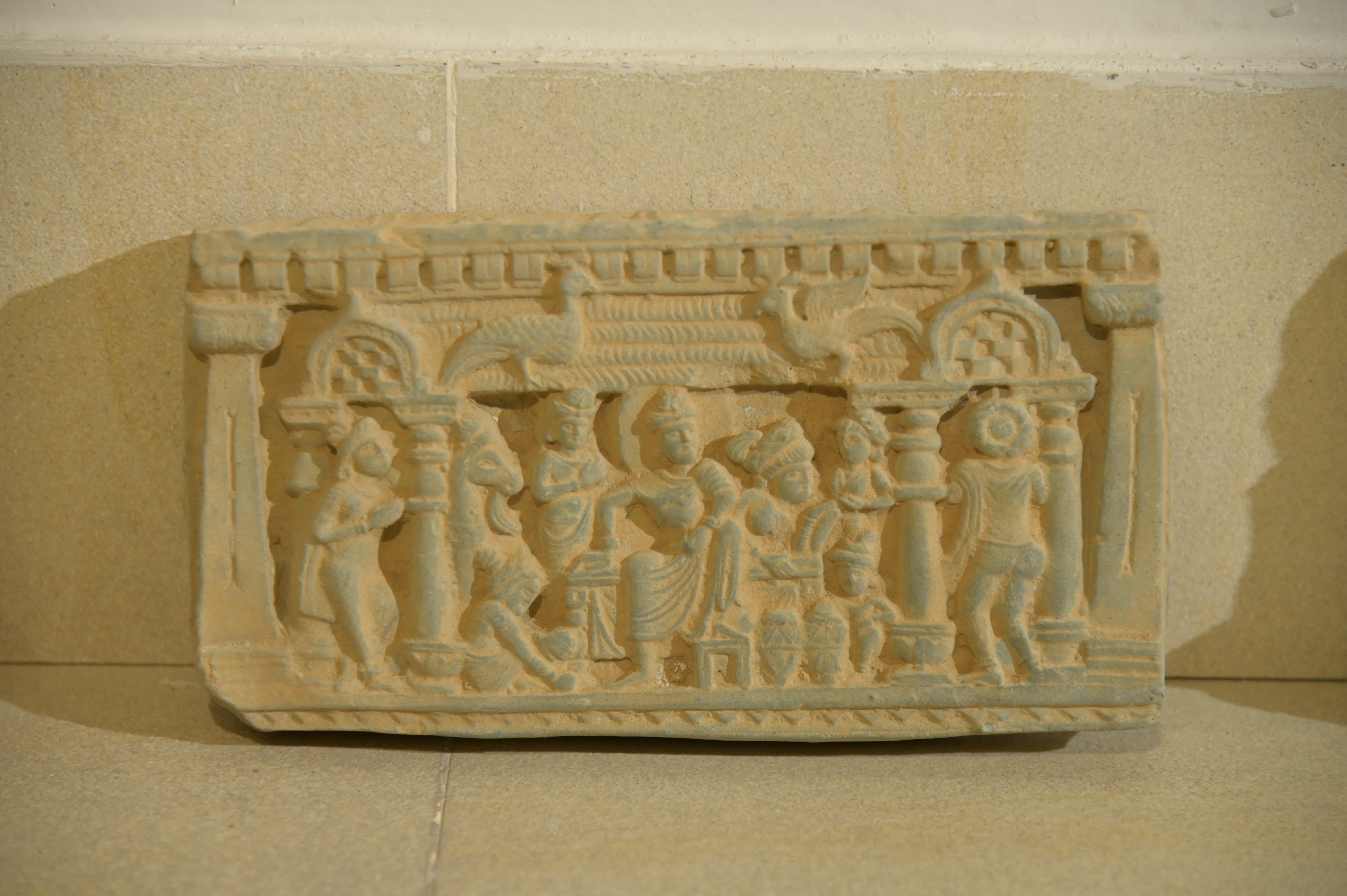 Ancient Gandhara-era stone carving depicting a historical scene