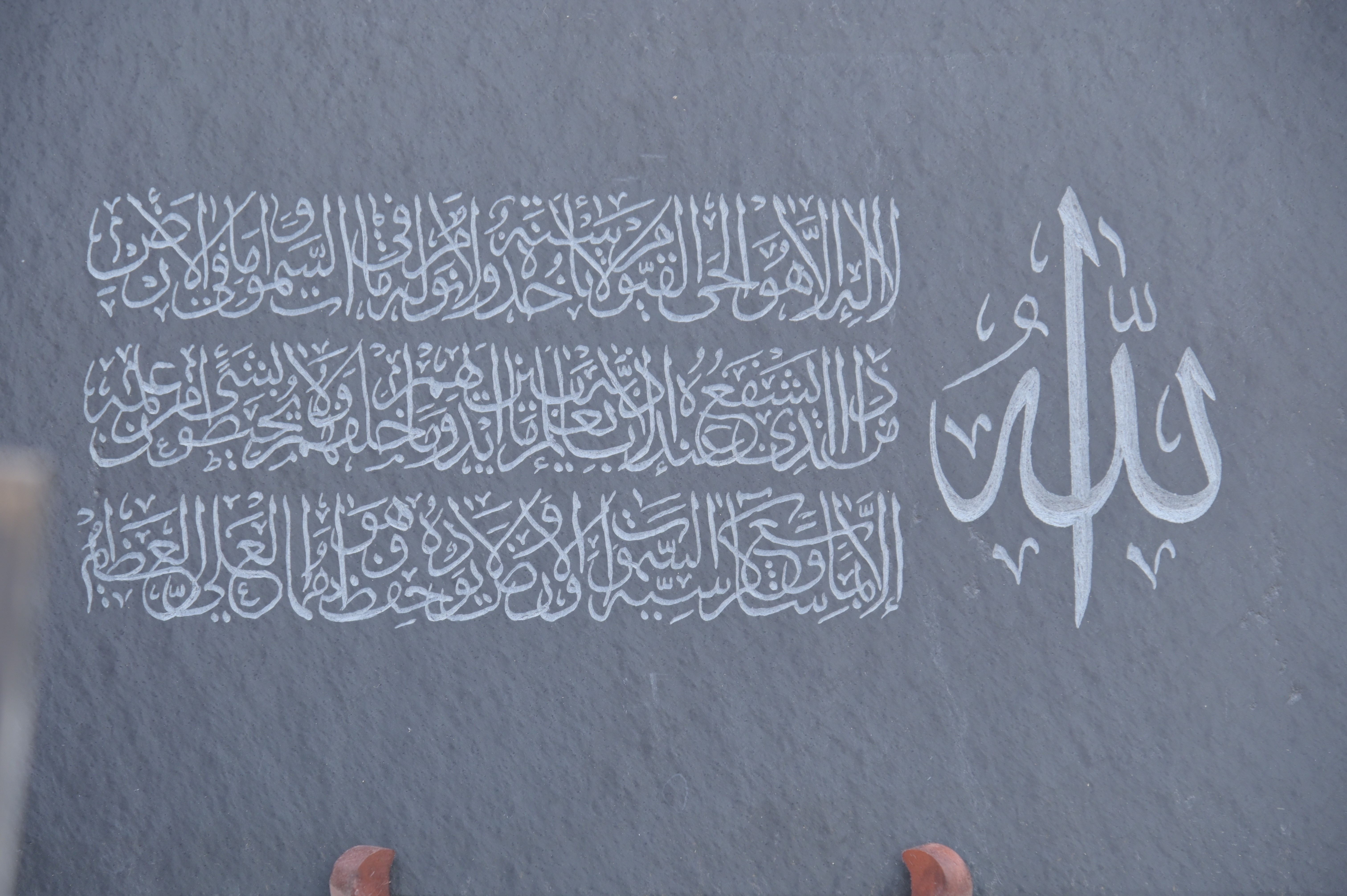 Intricate Arabic calligraphy engraved on a stone slab