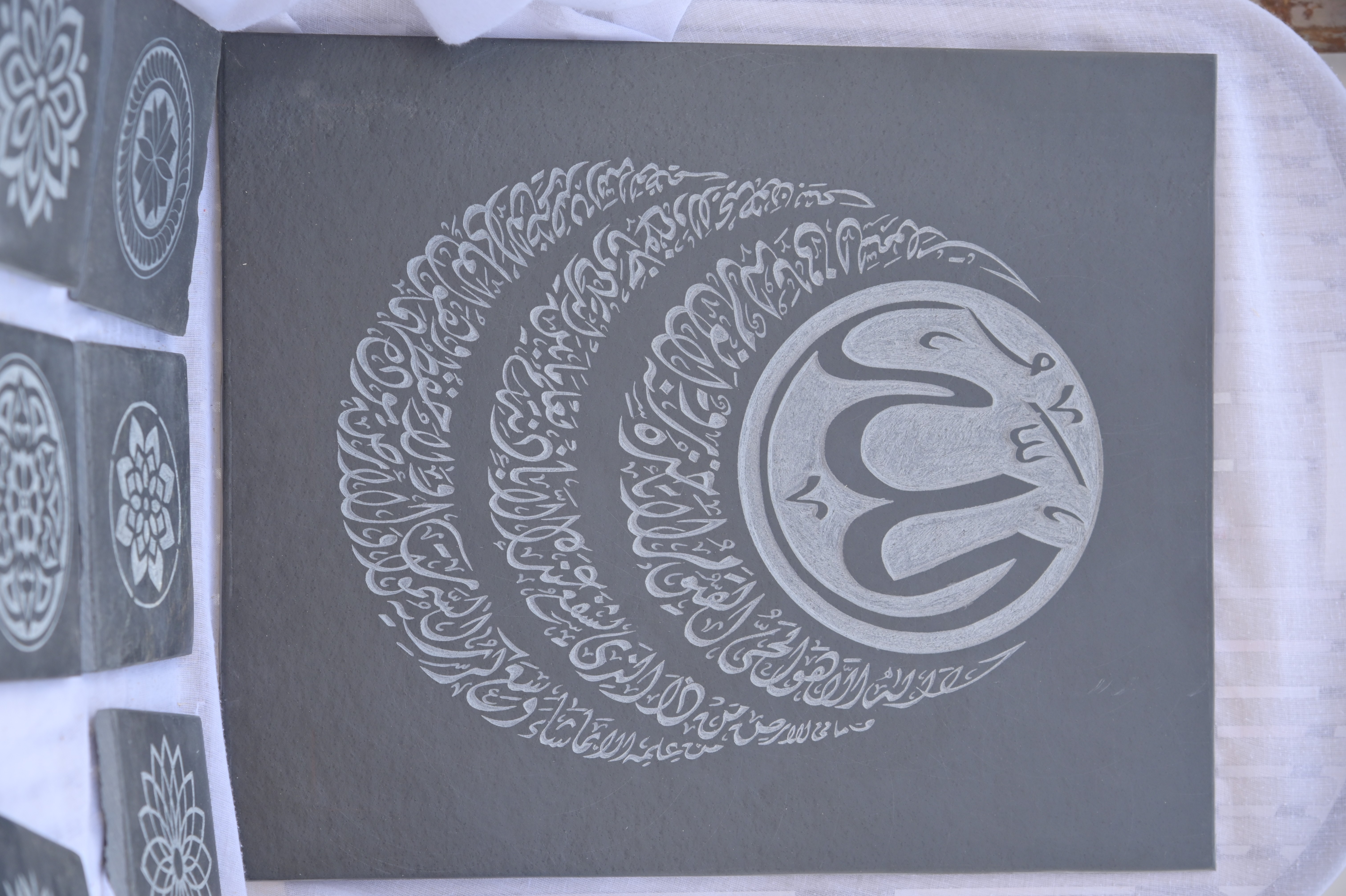Intricate Arabic calligraphy engraved on a stone slab