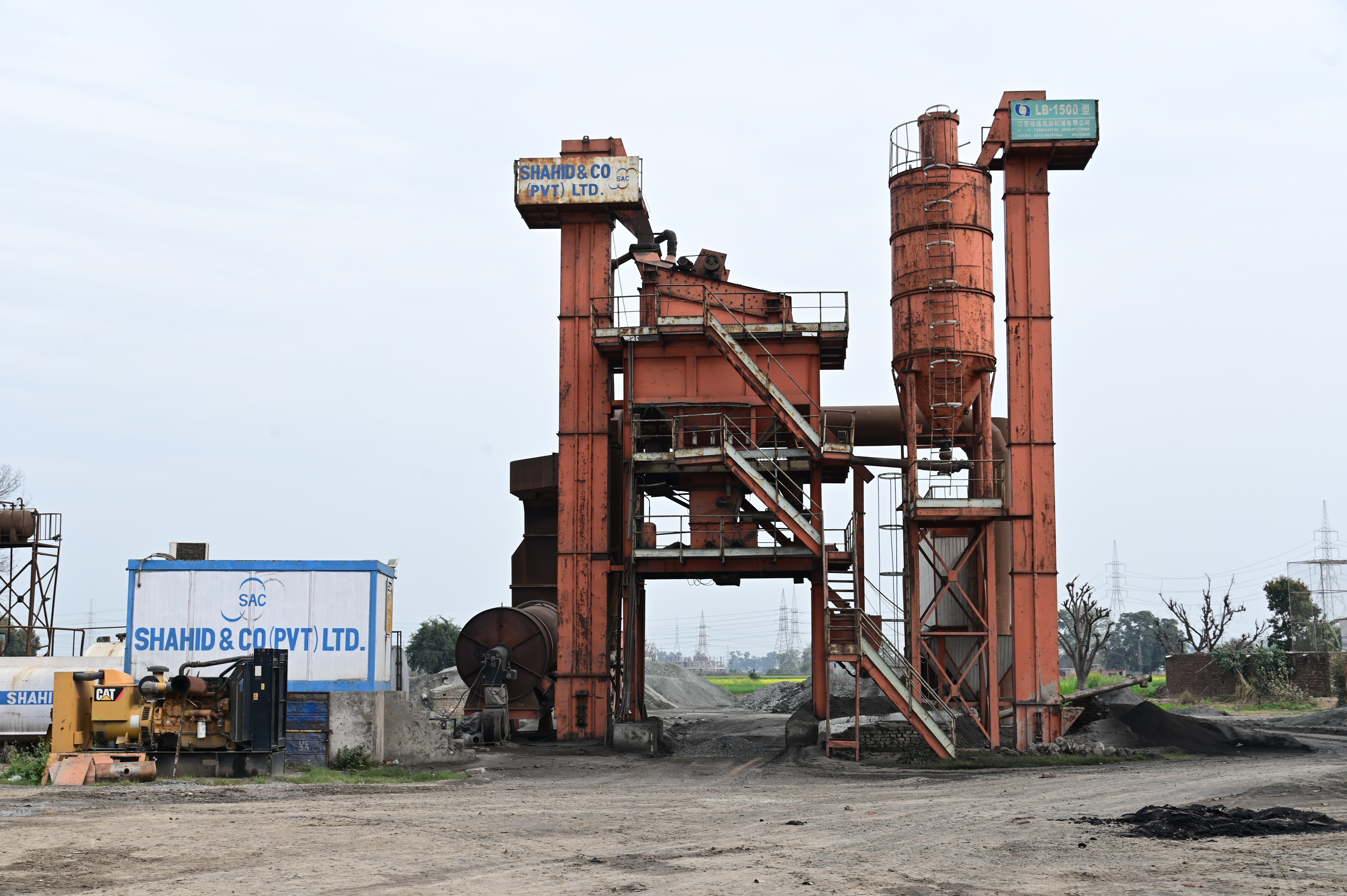 An industrial asphalt plant with rusted structures