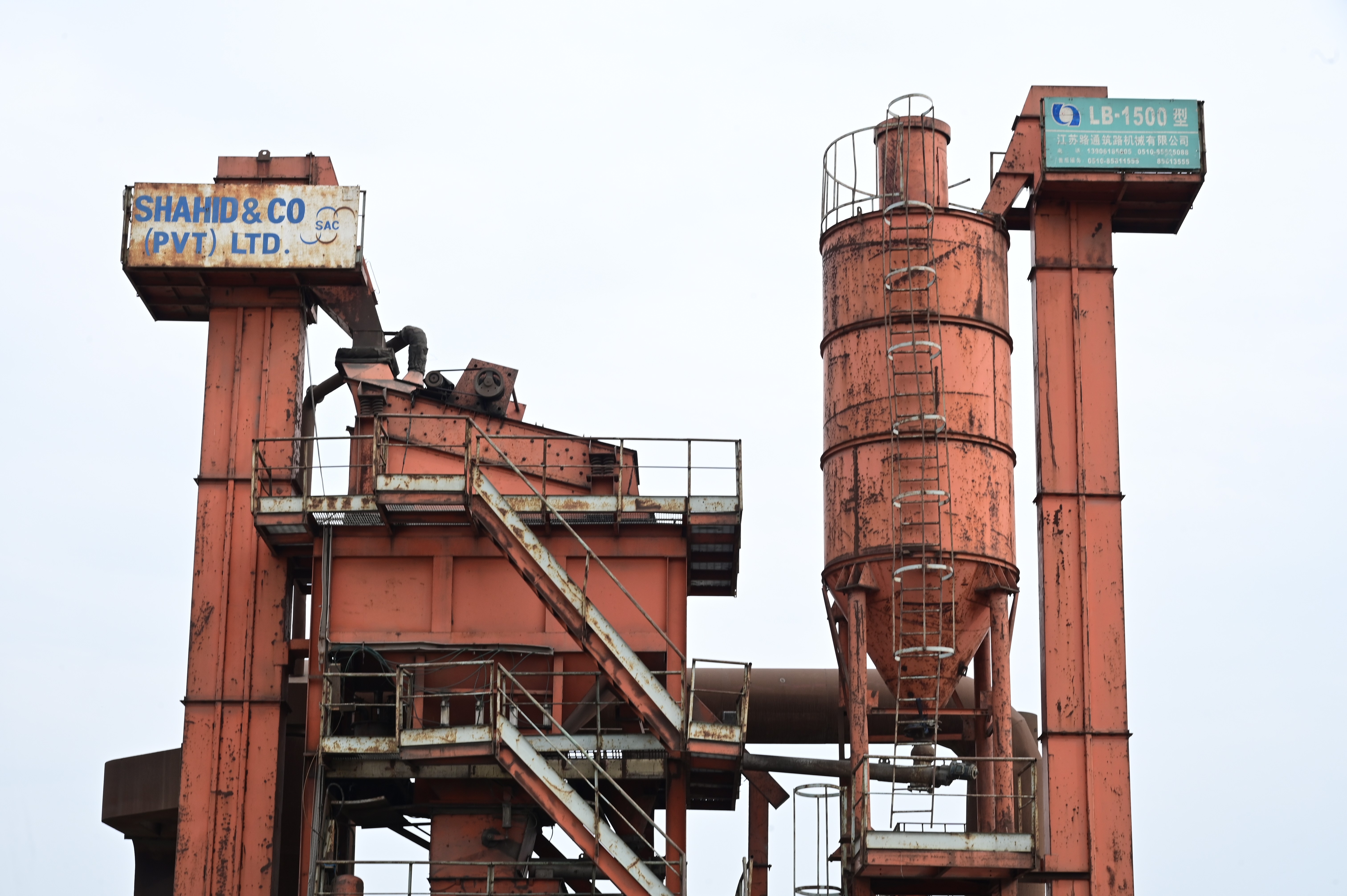 An industrial asphalt plant with rusted structures