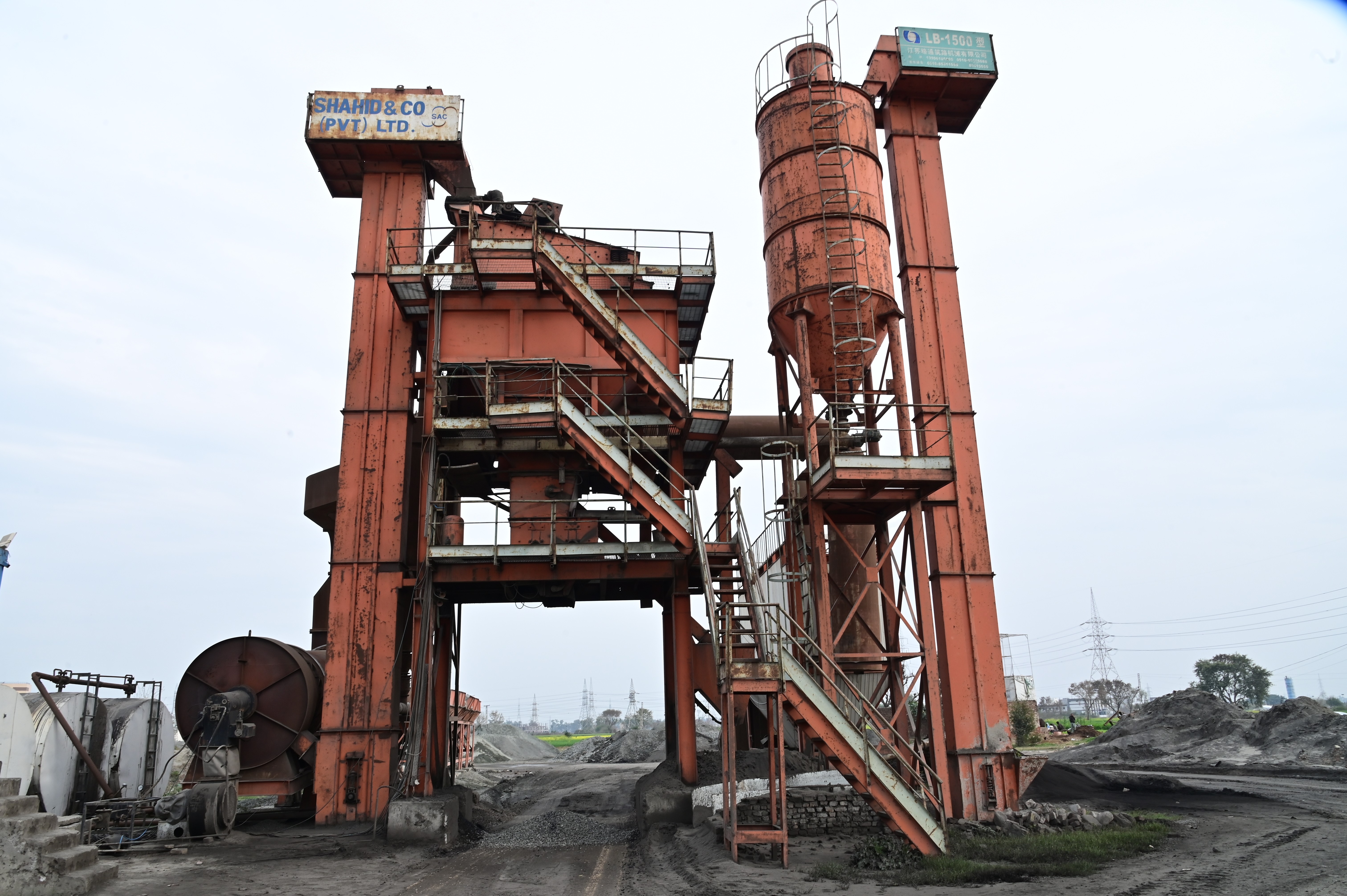 An industrial asphalt plant with rusted structures