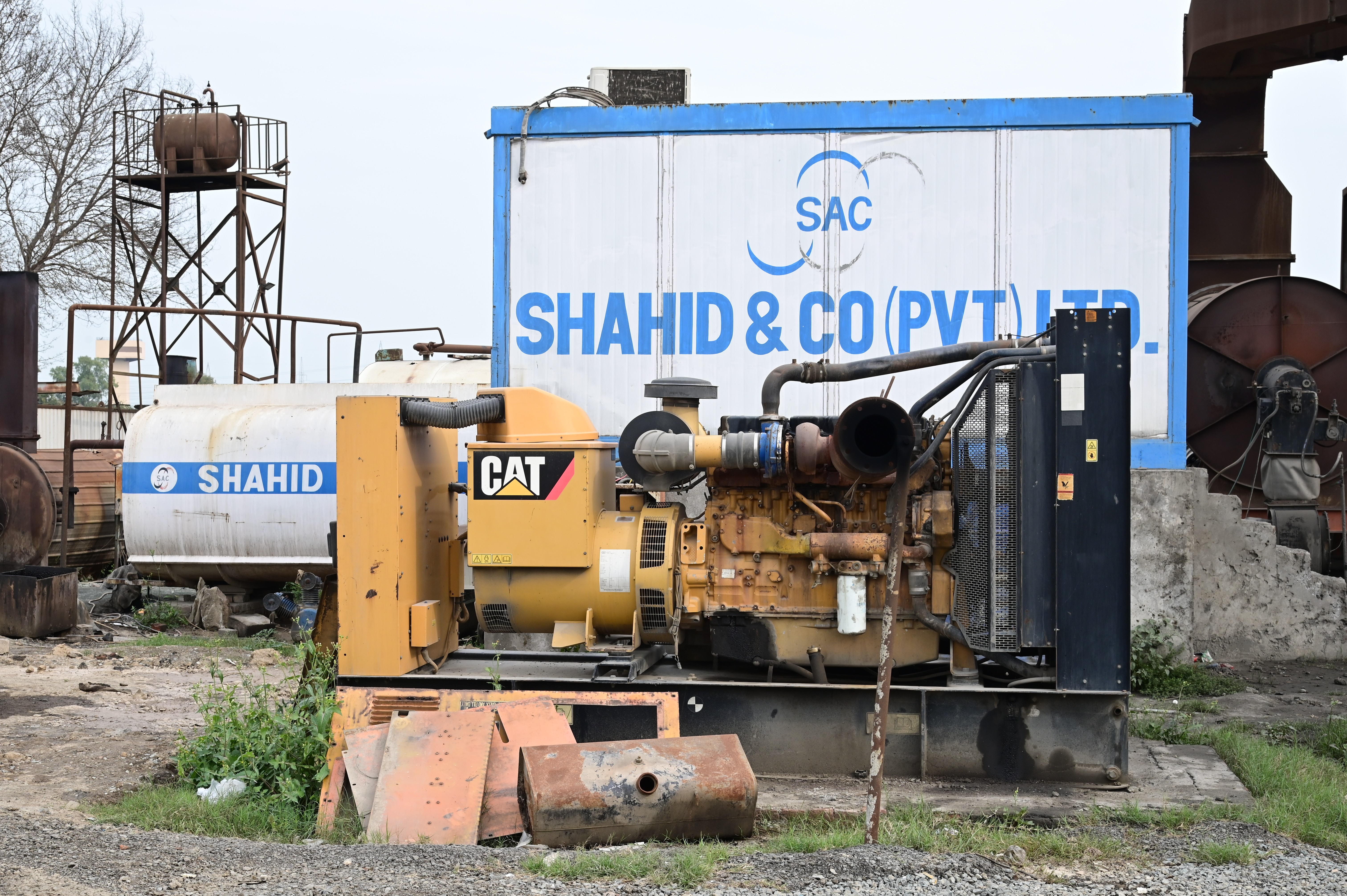 A generator set at a construction site with fuel storage tanks